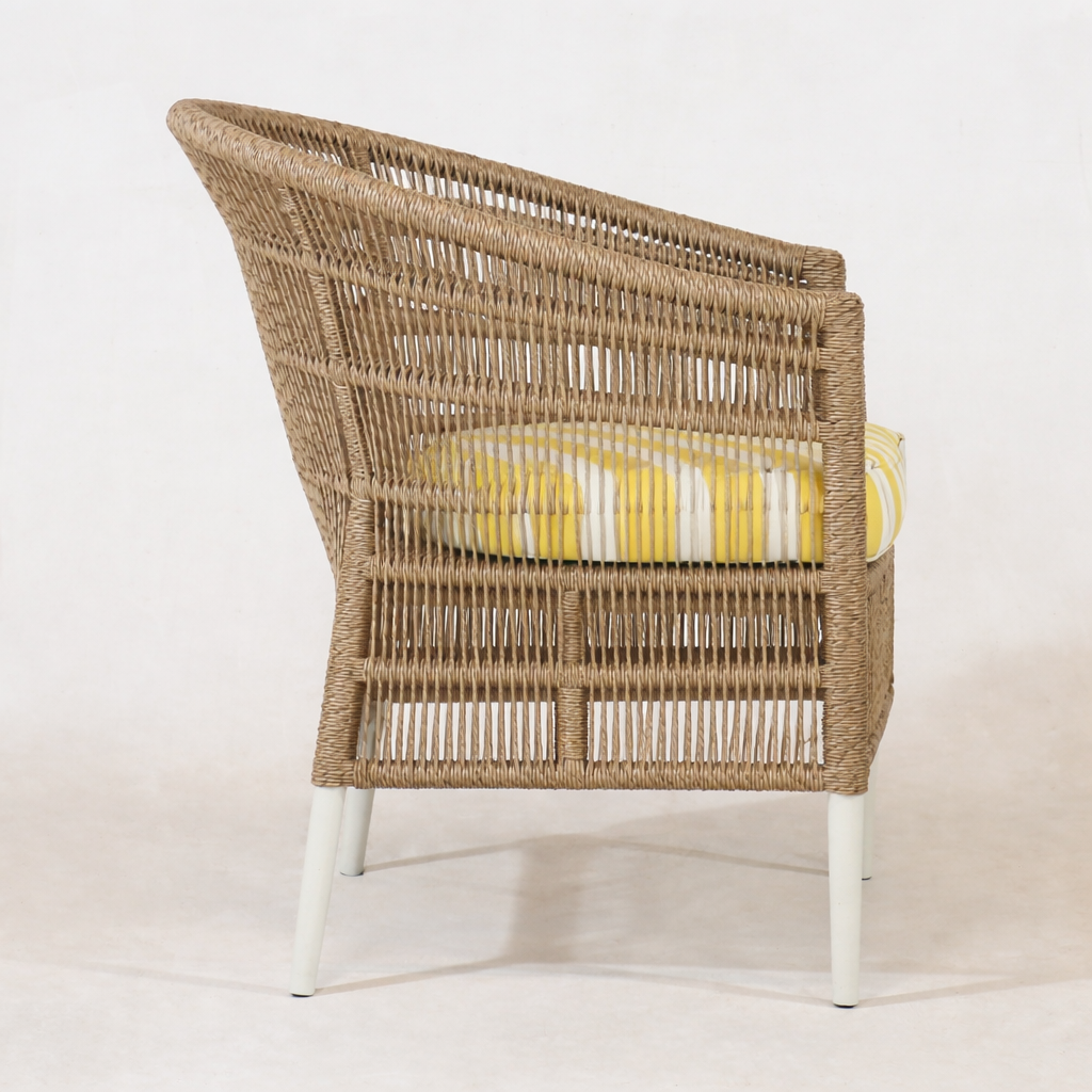 Side view of the Sirena Wicker chair with a yellow cushion on a white background by interiortonic.com