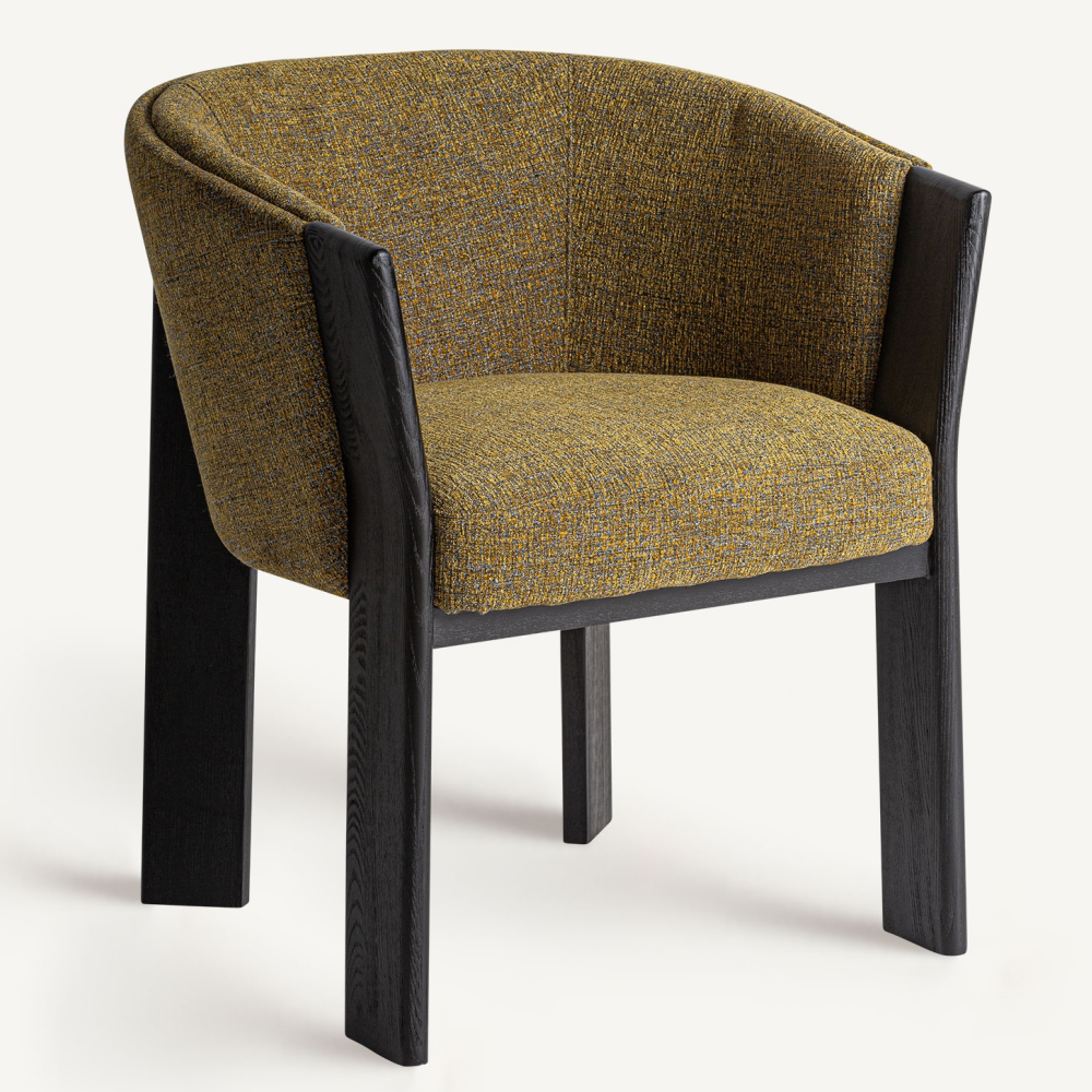 Modern curved barrel dining chair with black-stained oak frame and mustard-yellow performance fabric upholstery, padded seat and low wraparound back with integrated arms.