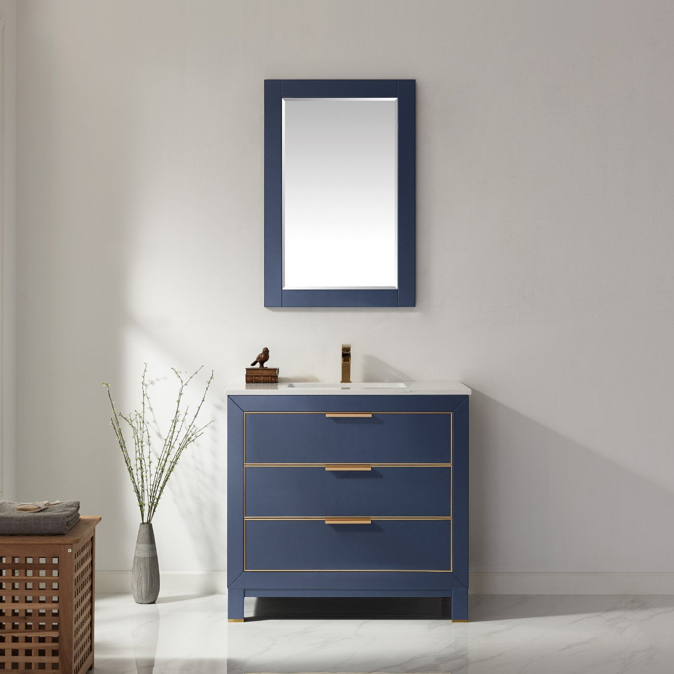 Navy blue solid wood 36-inch bathroom vanity with white stone top, three soft-close drawers accented with gold trim and brass handles, matching rectangular mirror and single gold faucet in a modern bathroom setting.
