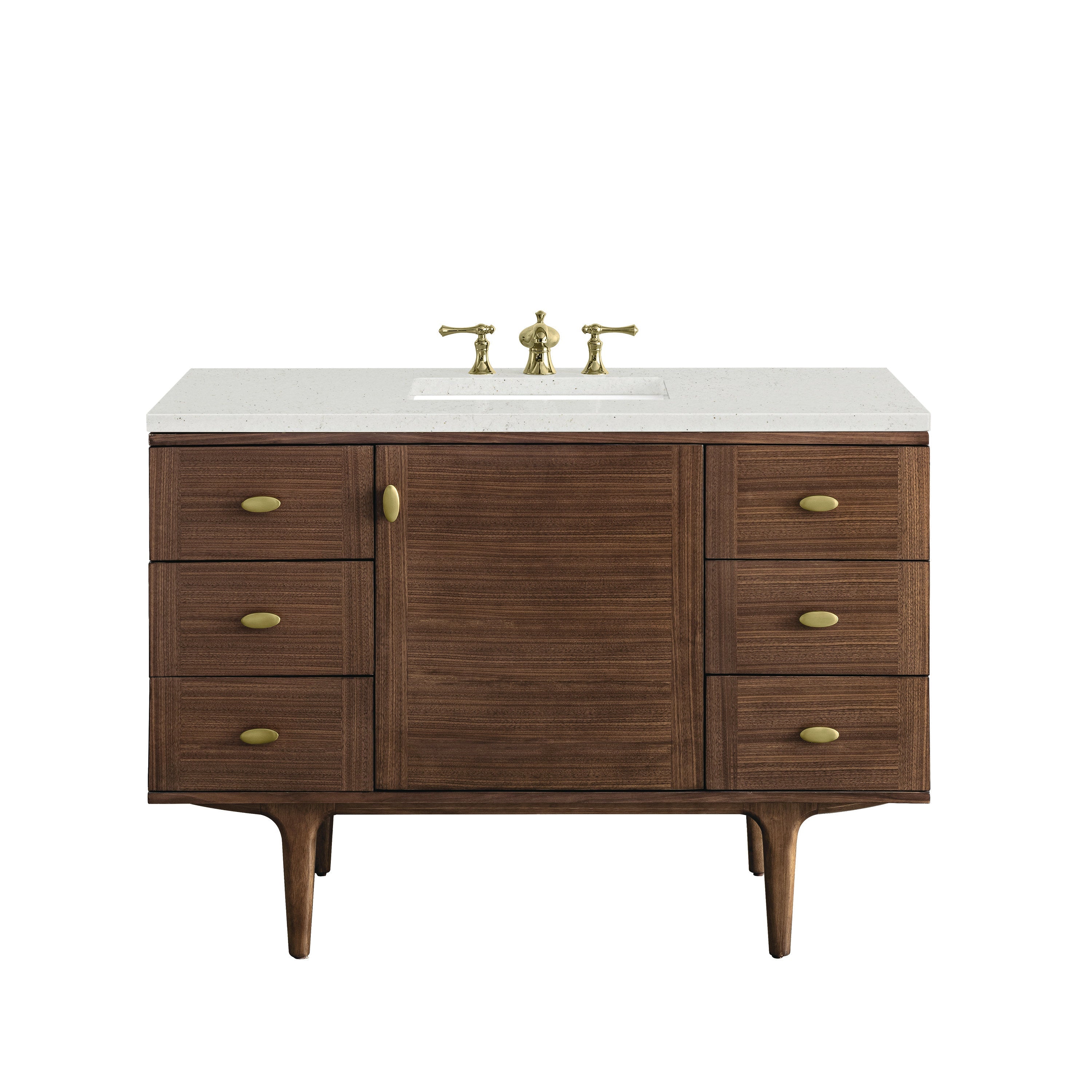 Mid-century walnut single-sink bathroom vanity with a speckled stone quartz top, rectangular undermount sink, brass widespread faucet and oval brass drawer pulls; freestanding design with tapered legs and central cabinet.
