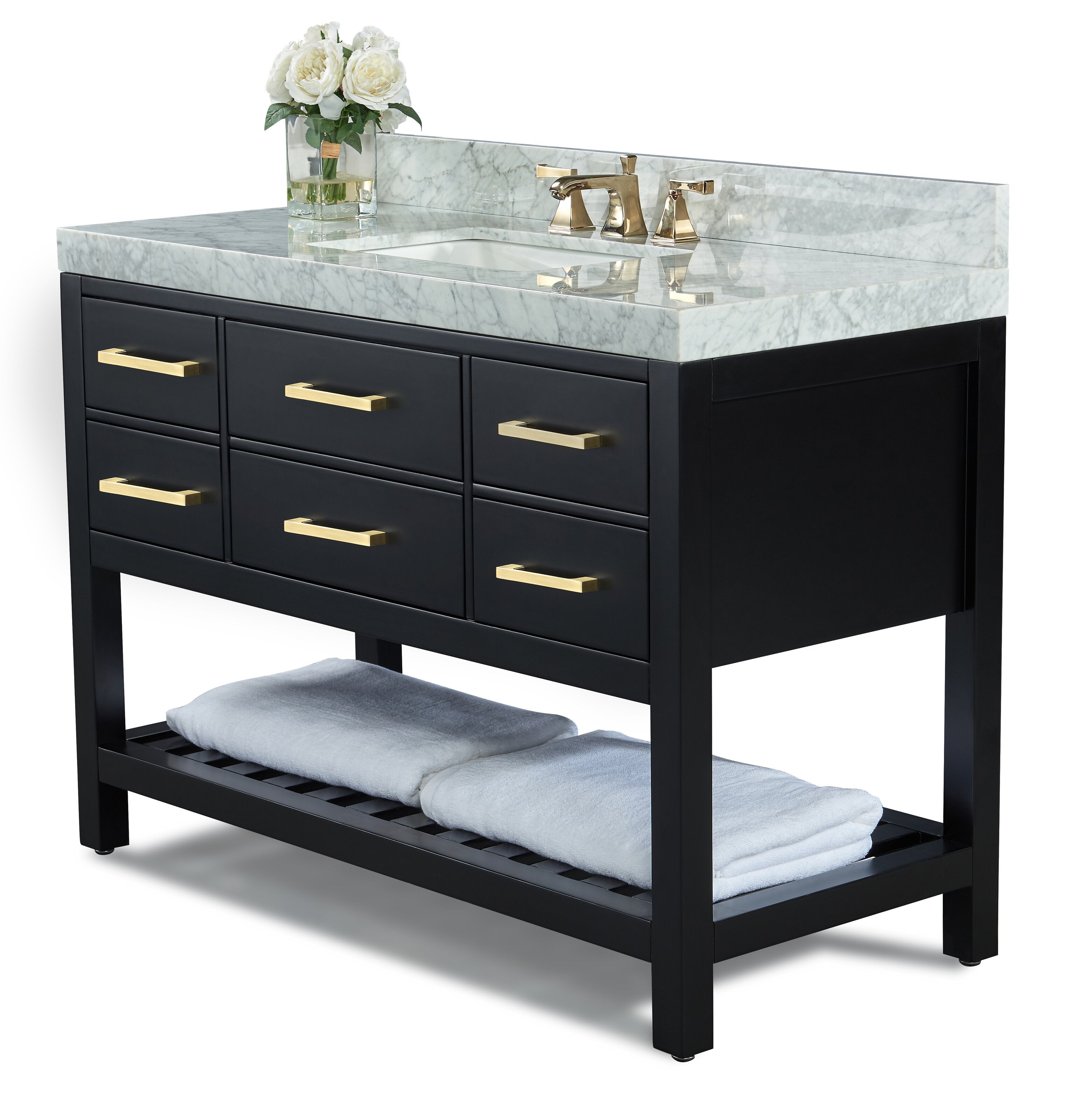 48-inch black solid wood single-sink vanity with stone marble countertop, integrated undermount ceramic sink, brushed brass faucet and matching drawer pulls, open slatted lower shelf with folded white towels and a vase of white flowers.