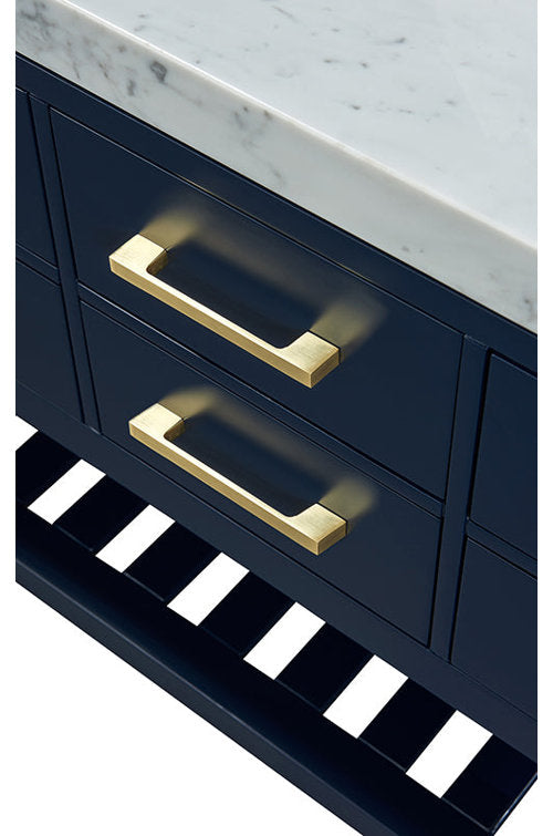 Close-up of a modern dark navy solid-wood vanity with a white marble stone top, two drawers fitted with brushed gold rectangular pulls and a slatted open shelf along the base.