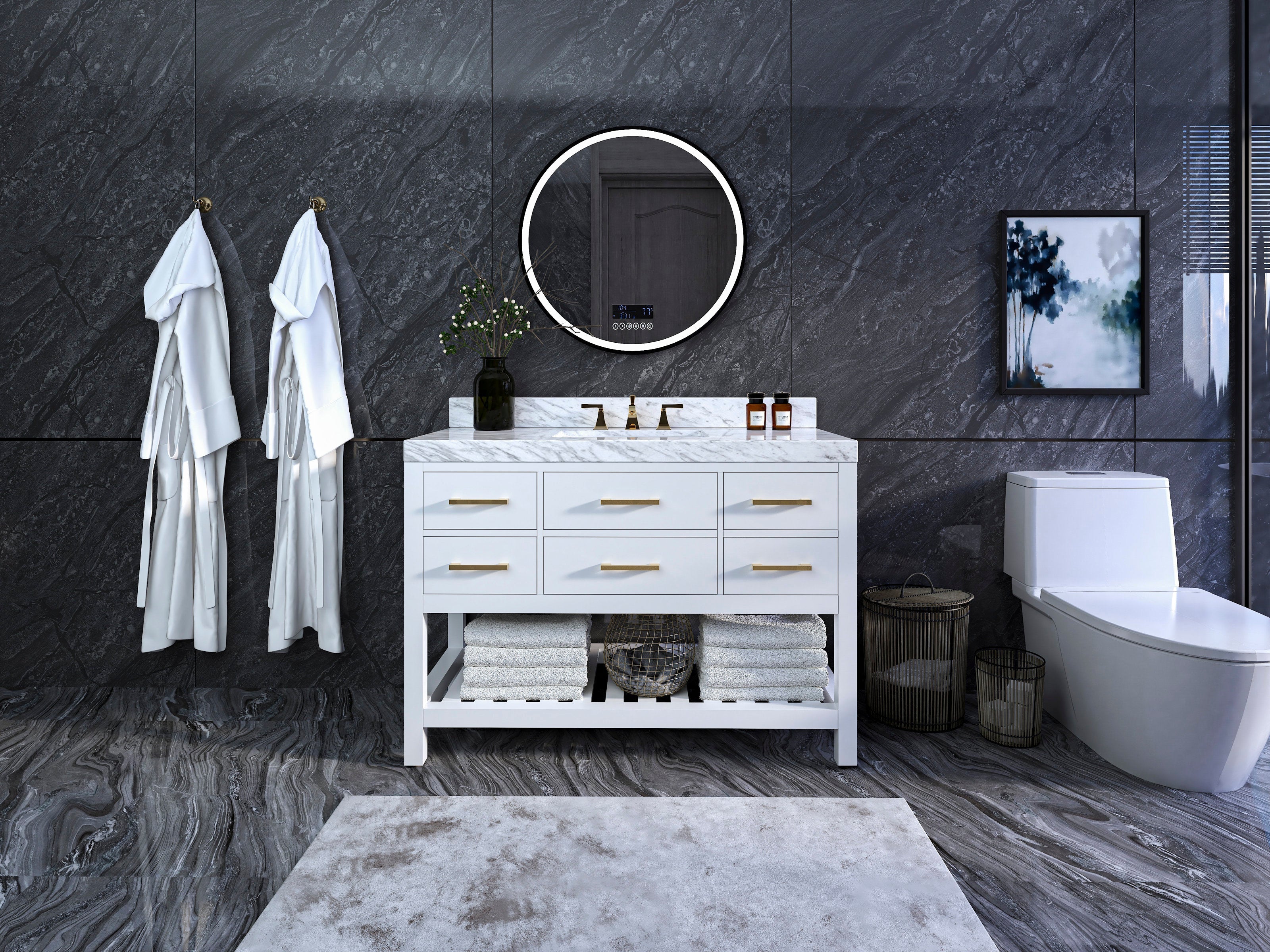 Freestanding white solid-wood vanity with marble top and brushed-gold handles, single ceramic sink and round LED mirror above; open lower shelf stacked with towels, dark stone marble walls and floor, white toilet at right.