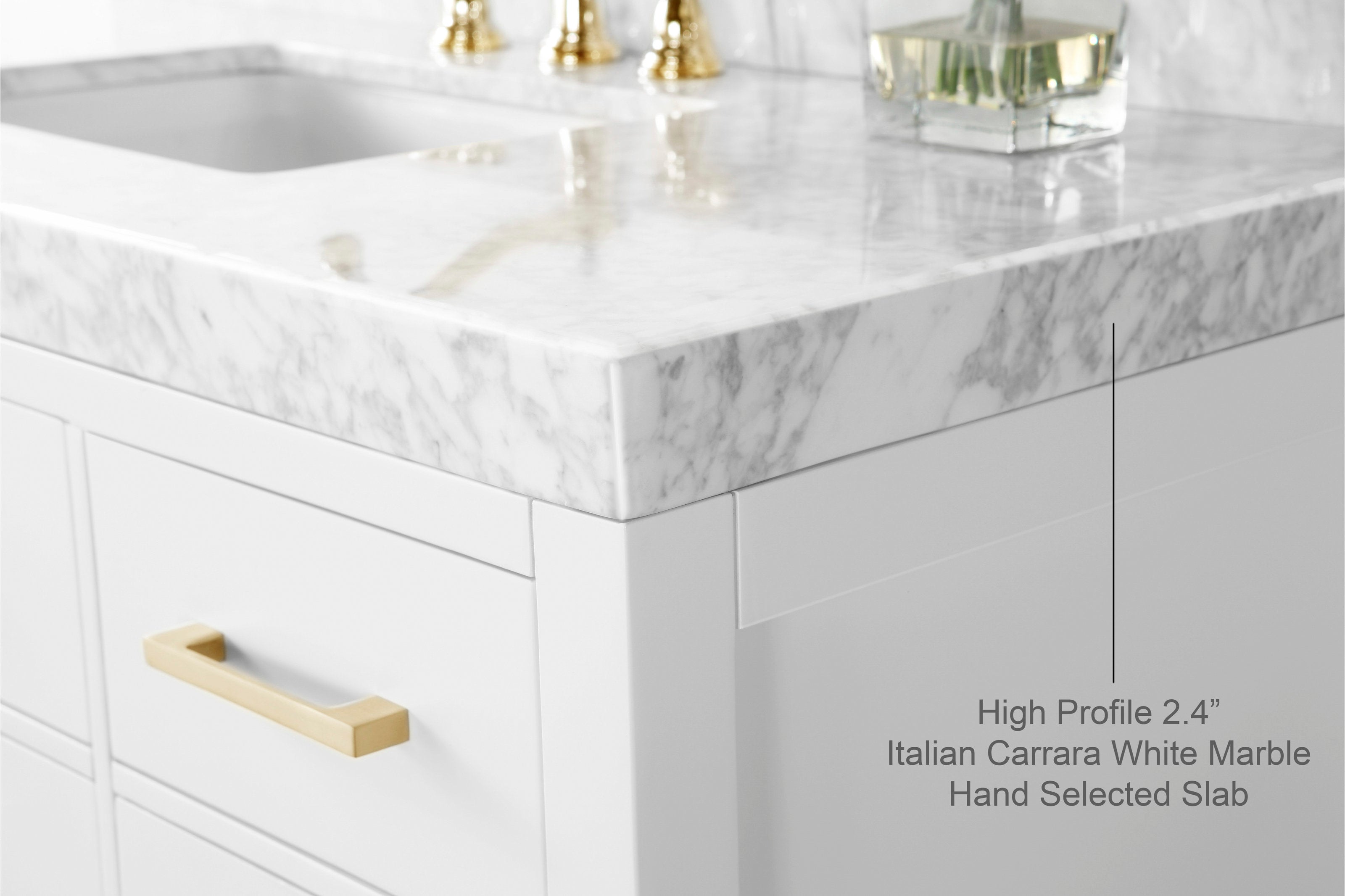Close-up of a modern white bathroom vanity corner with a 2.4-inch high-profile Italian Carrara white marble countertop, undermount sink opening, white solid wood cabinetry and a brushed brass drawer pull.