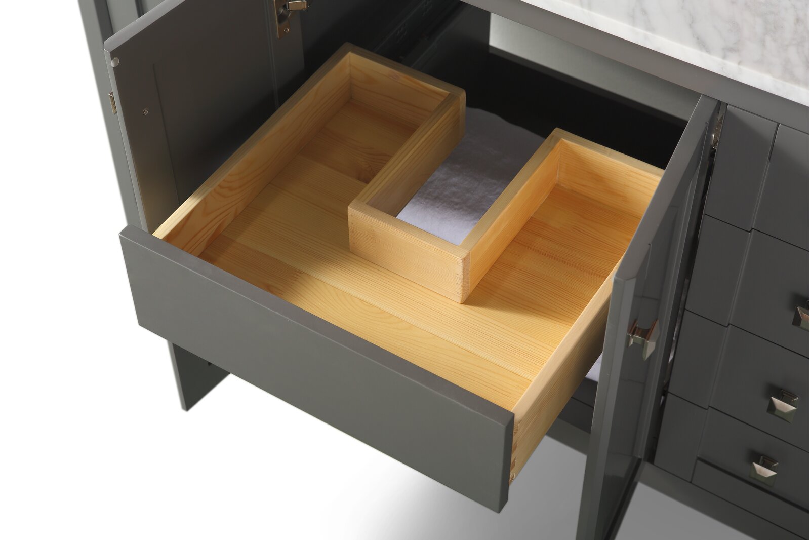 Open stone-colored modern bathroom vanity drawer revealing a natural solid wood interior and a removable wooden organizer tray, with a white marble countertop edge visible above.