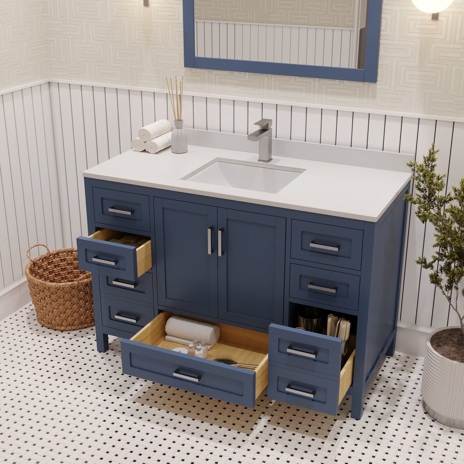 Modern 48-inch solid wood bathroom vanity with a stone countertop and integrated rectangular ceramic sink; blue painted cabinet with multiple open drawers showing wooden interiors, brushed metal pulls, wicker basket and potted plant.