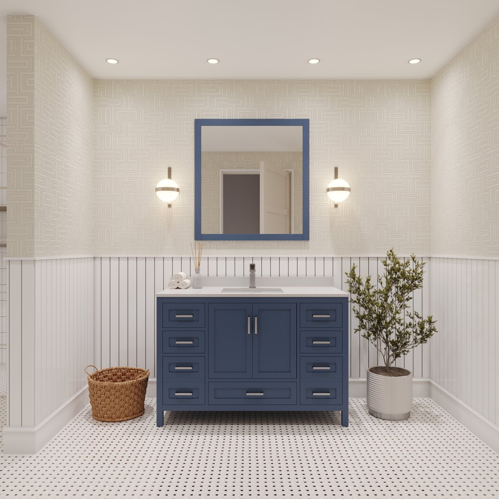 Modern 48-inch solid wood single-sink vanity with a white stone countertop and navy-blue painted cabinet, matching square mirror, dual wall sconces, recessed-handle drawers, wicker basket and potted plant in a light bathroom.
