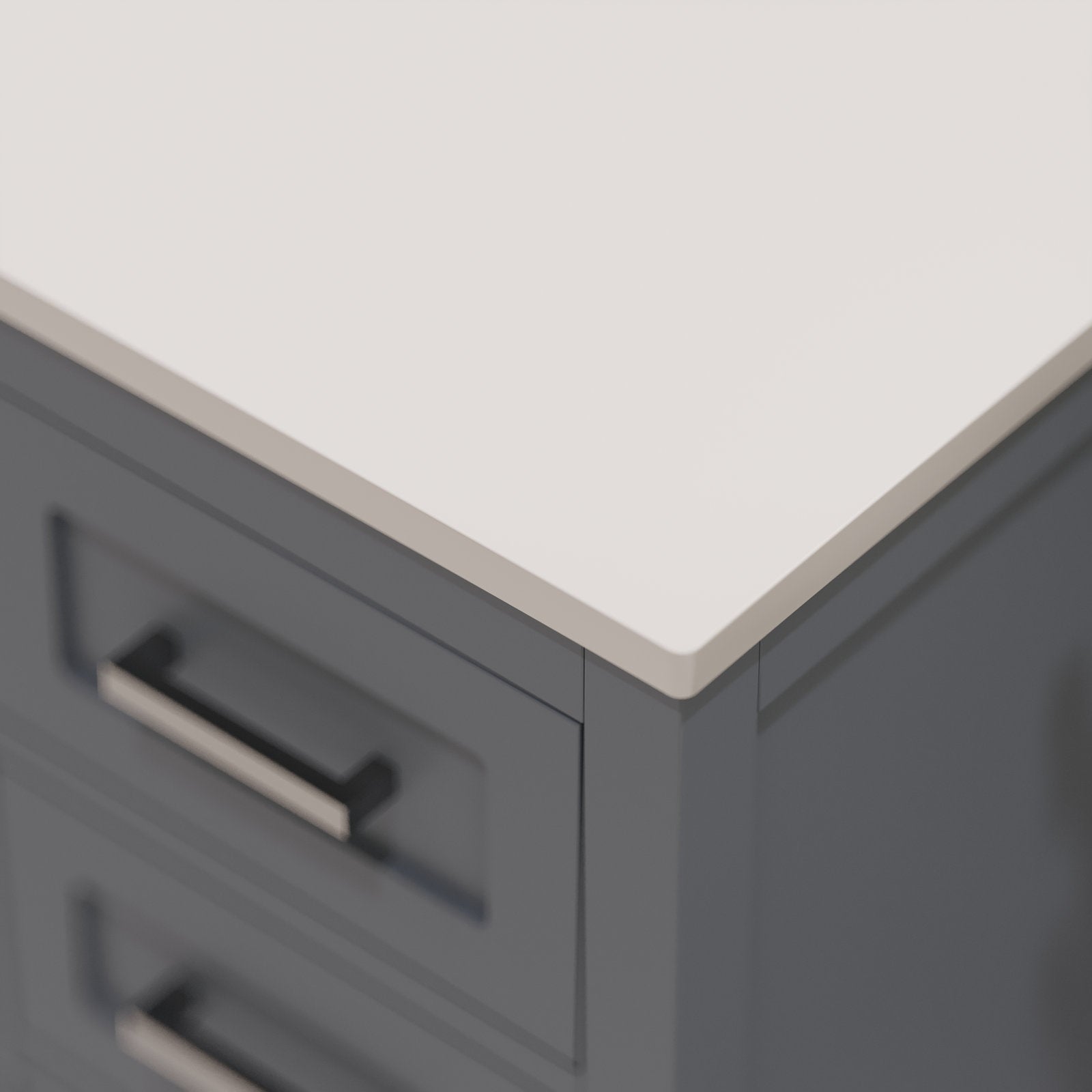 Close-up of a stone top meeting a charcoal-gray solid wood vanity corner, showing recessed drawer fronts and brushed metal bar handles in a modern contemporary bathroom vanity style.