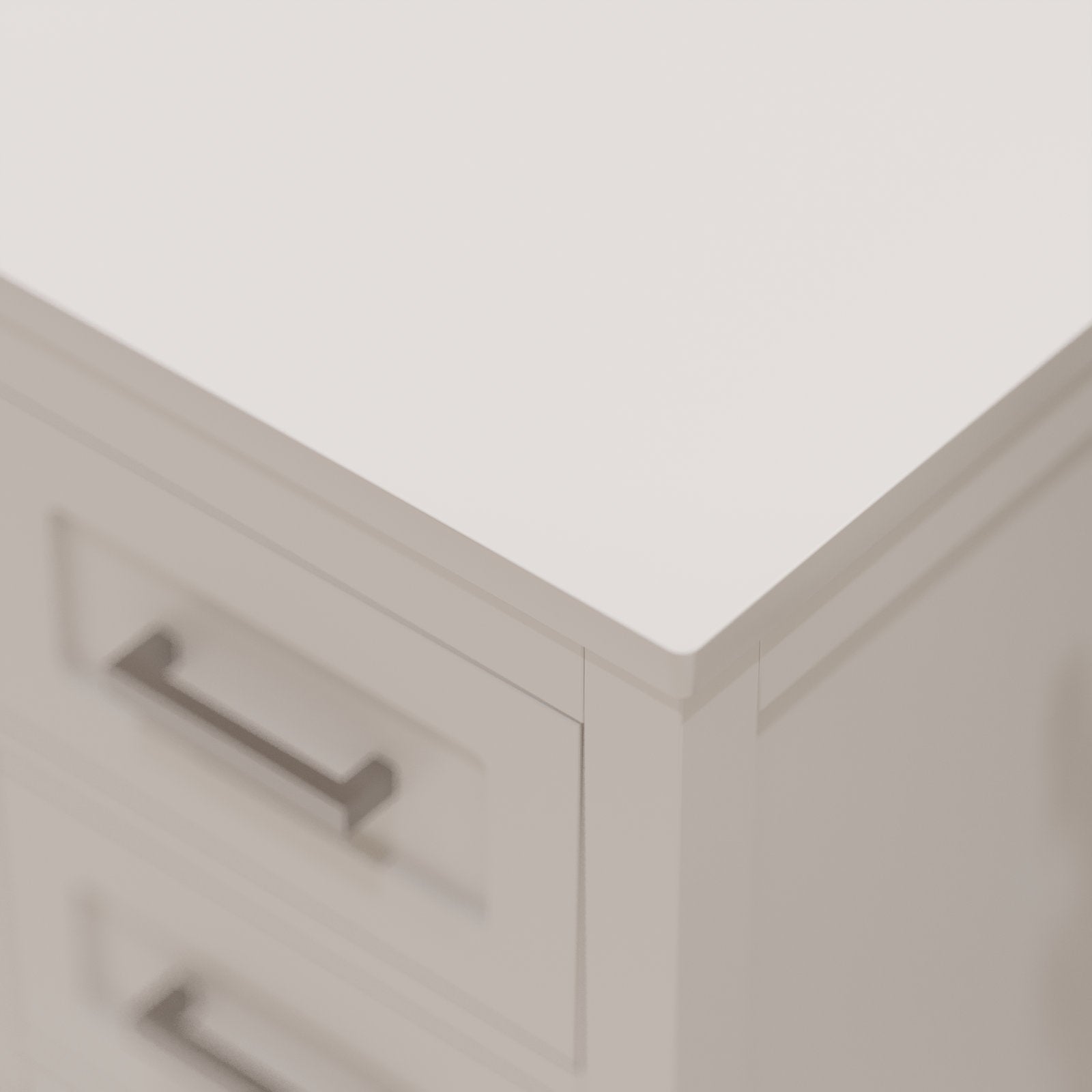Close-up of a stone-colored solid wood bathroom vanity corner showing the smooth stone countertop edge, paneled drawer face and a modern rectangular metal drawer pull.