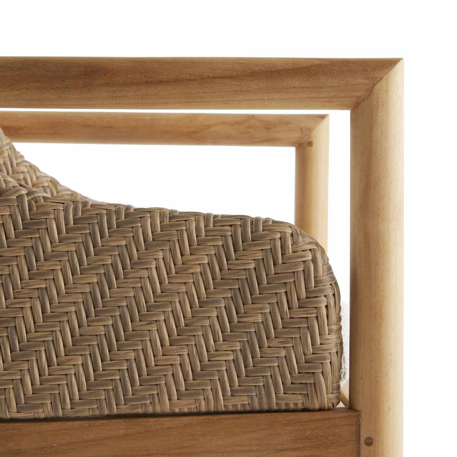 Close-up of a natural teak wood frame with tightly woven neutral-tone wicker back, highlighting the texture and a hint of a neutral fabric cushion at the edge.