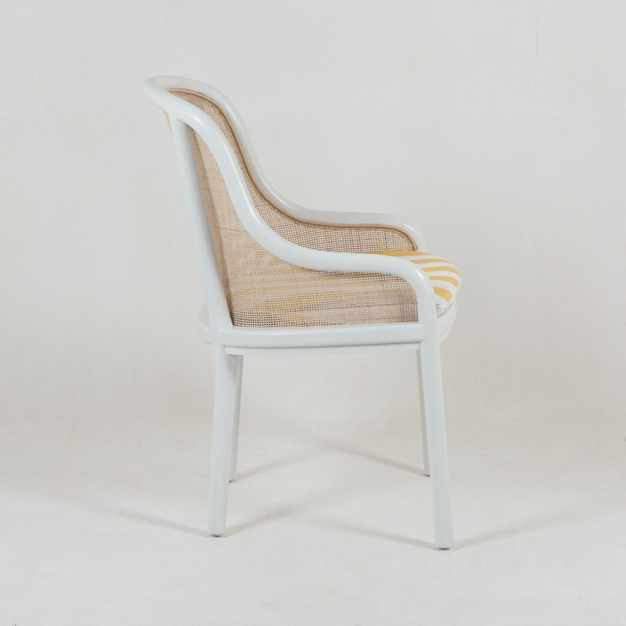 The INTERIORTONIC Landmark Bentwood & Cane Dining Chair features caned sides, a curved back and legs, and a yellow and white striped seat cushion. This vintage-style chair is shown in profile against a plain white background.