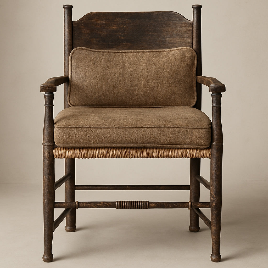 Farmhouse armchair with a dark-stained solid wood frame, woven rush seat edge and brown fabric-upholstered seat cushion and lumbar pillow, featuring turned legs, spindled arms and a full wooden back.
