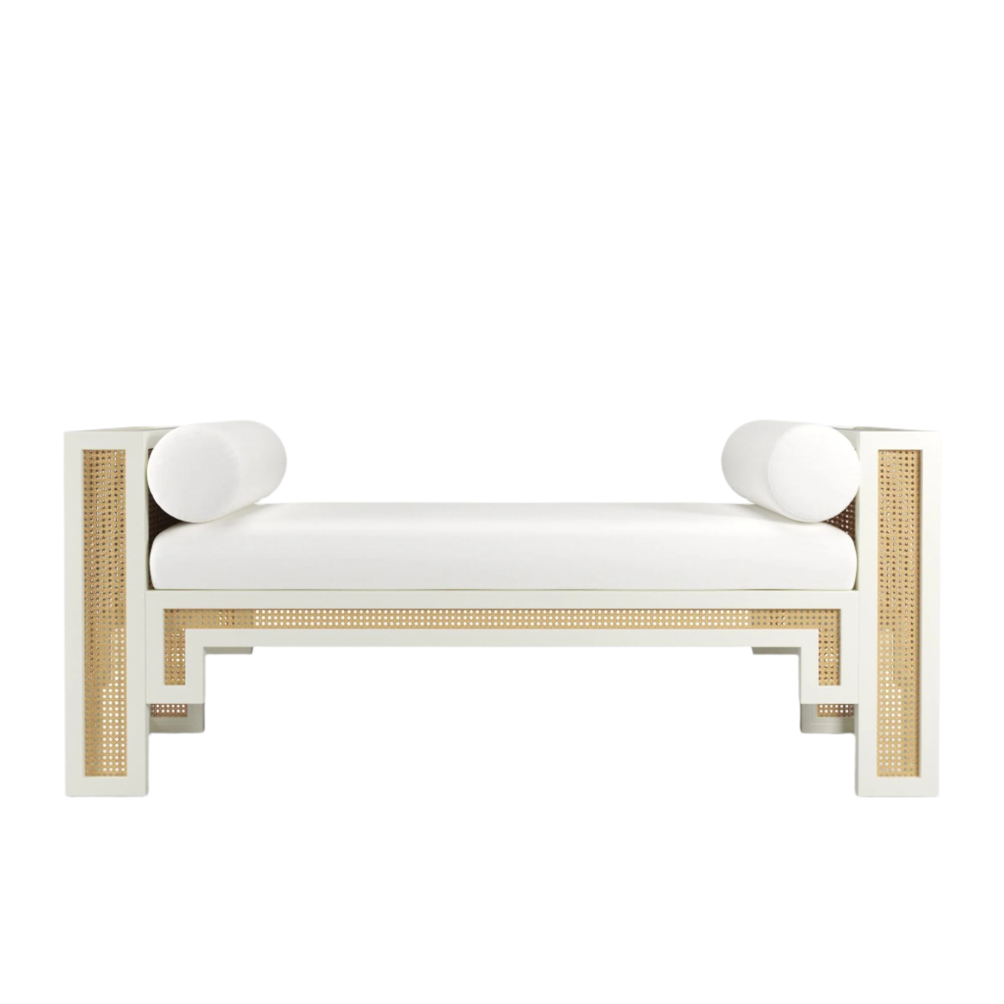 White-painted solid wood bench with natural rattan cane panels, cushioned white fabric seat and two round bolster pillows, boho-contemporary end-of-bed or entryway bench.