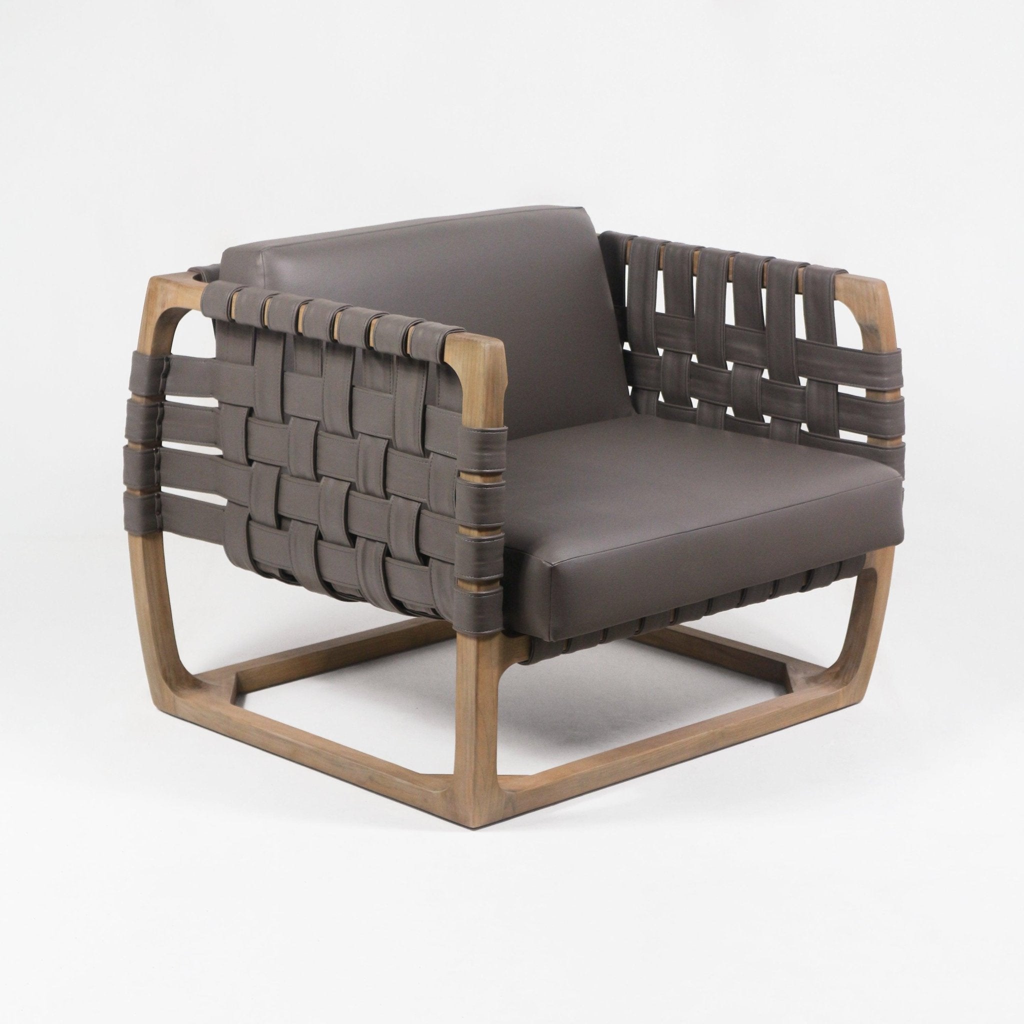 Modern low-back lounge chair with a natural solid wood frame and wide woven brown faux-leather webbing on the sides and back, featuring a matching brown cushioned seat and backrest and open geometric base.