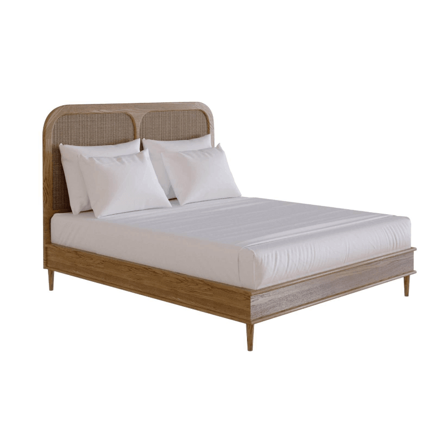 Low-profile teak platform bed with a rounded rattan cane headboard, tapered wooden legs and white bedding, shown in a natural teak finish with Scandinavian-Boho styling.