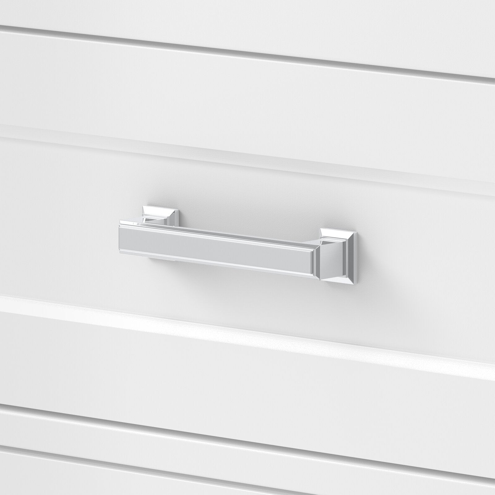 Close-up of a polished chrome rectangular drawer pull mounted on a white modern solid-wood vanity drawer, showing square rosettes and recessed panel detailing.