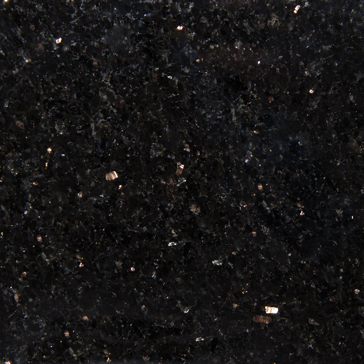 Close-up of a polished black quartz countertop surface showing scattered reflective metallic and gray mineral flecks