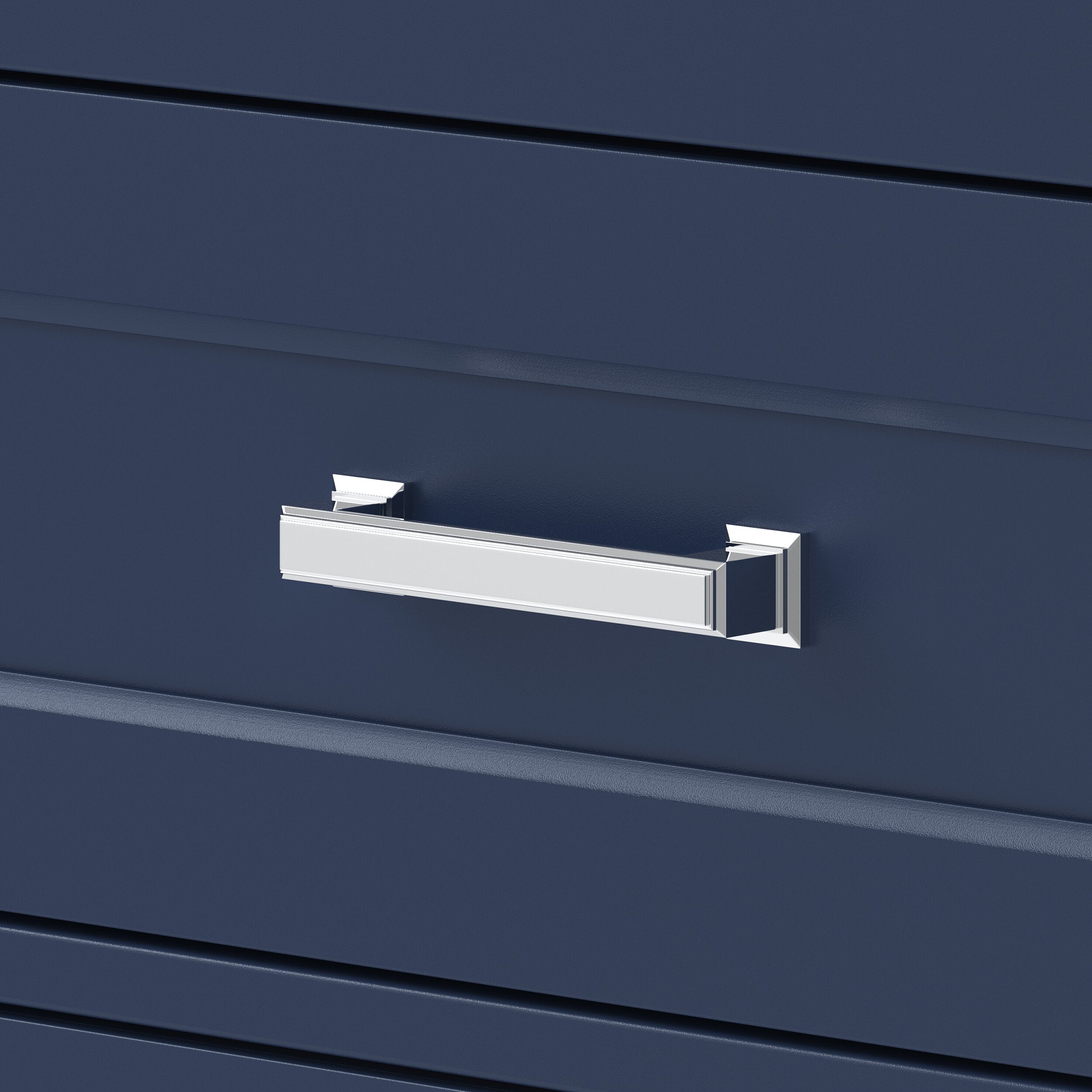 Close-up of a polished chrome rectangular drawer pull on a black solid-wood vanity drawer front with shallow recessed paneling, highlighting the modern style and metal finish.