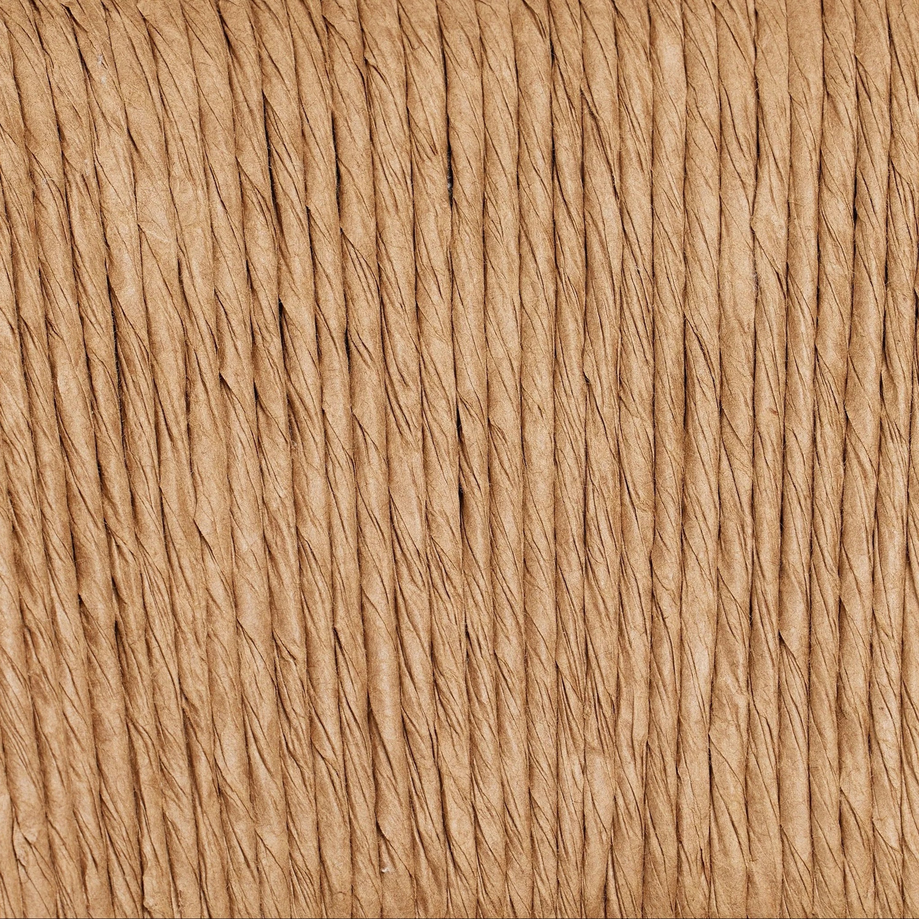Close-up of natural tan rope weave showing tightly twisted vertical fibers and textured woven pattern used on the stool's C-back.