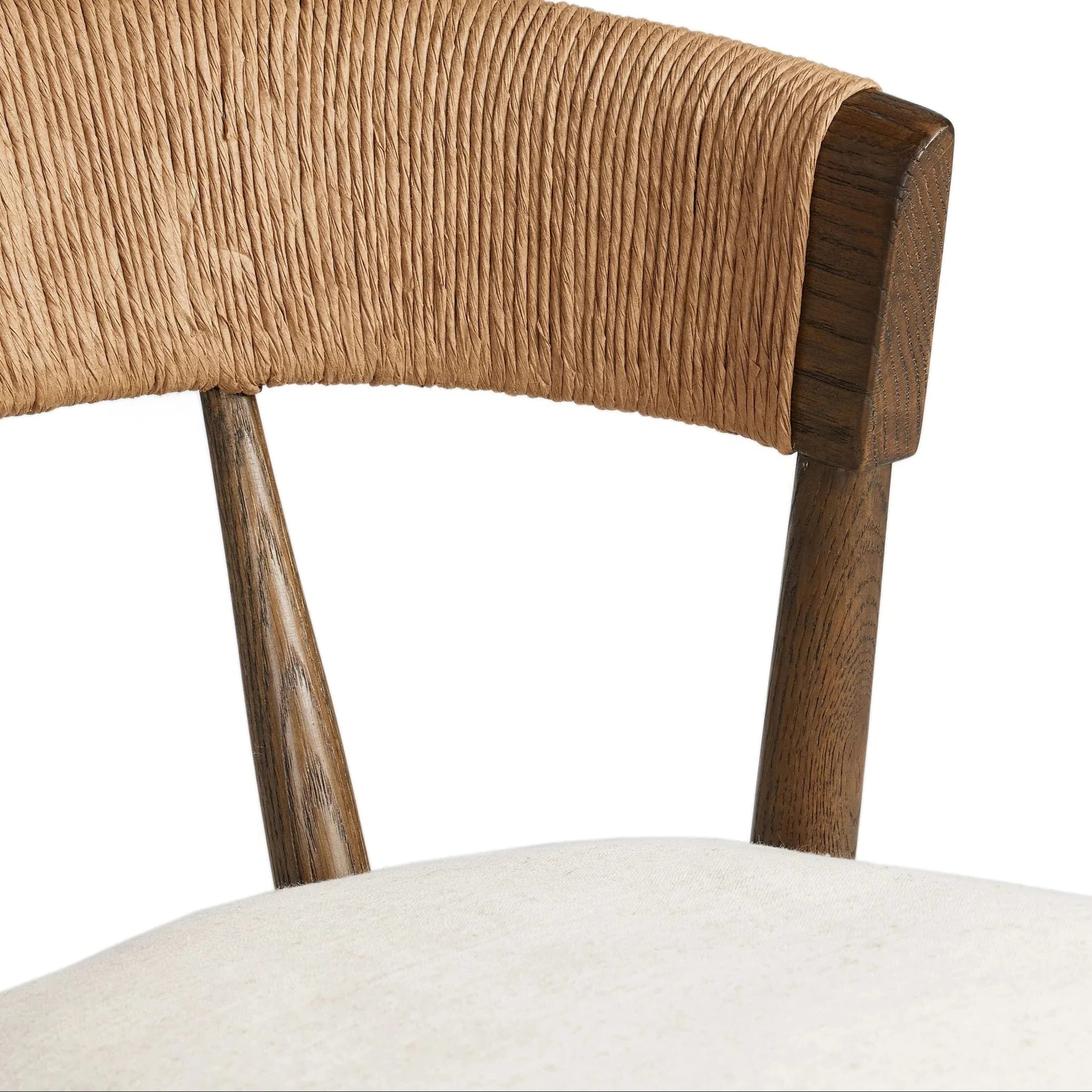 Close-up of a natural rope-wrapped C-shaped backrest on a rustic natural wood frame with a cream upholstered cushioned seat.