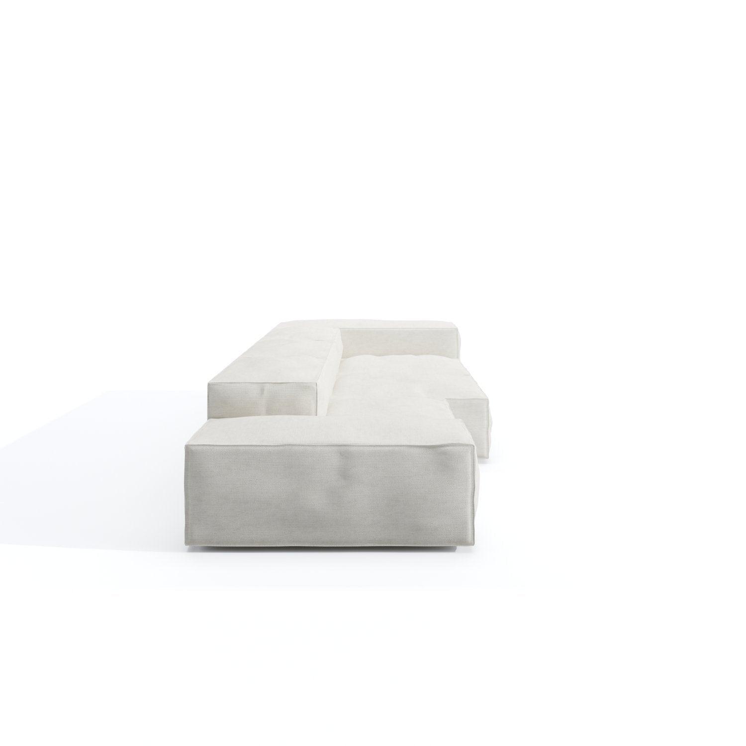 Low-profile modern sectional sofa upholstered in off-white loose-linen fabric, shown from the front with deep cushioned seats, squared arms and modular block design on low hidden legs against a white background.