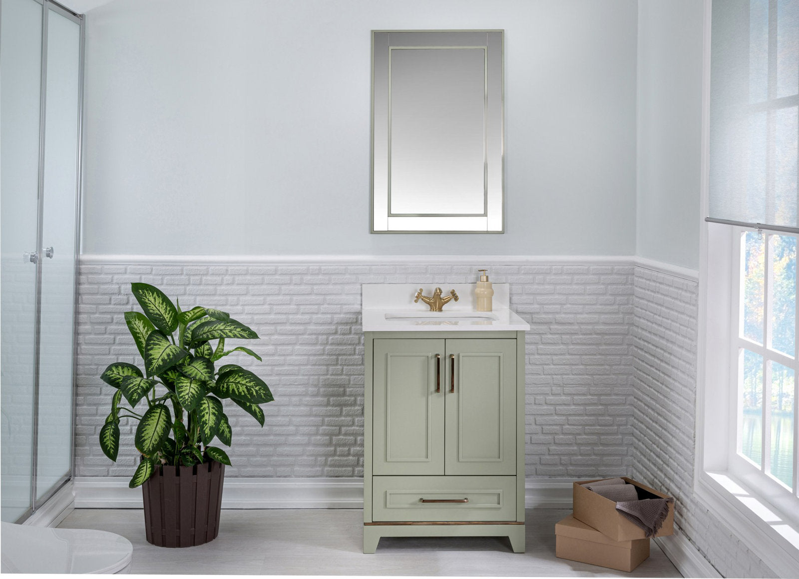 Freestanding modern solid wood bathroom vanity in stone finish with white stone countertop and integrated ceramic sink, brass faucet and rectangular mirror above, shown with a potted plant and storage boxes.