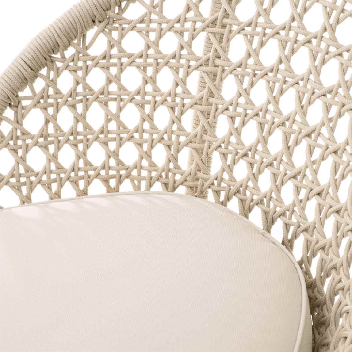 Close-up of a teak outdoor bar stool showing a light natural woven rope back in a lattice pattern and a beige fabric upholstered seat cushion with a piped edge.
