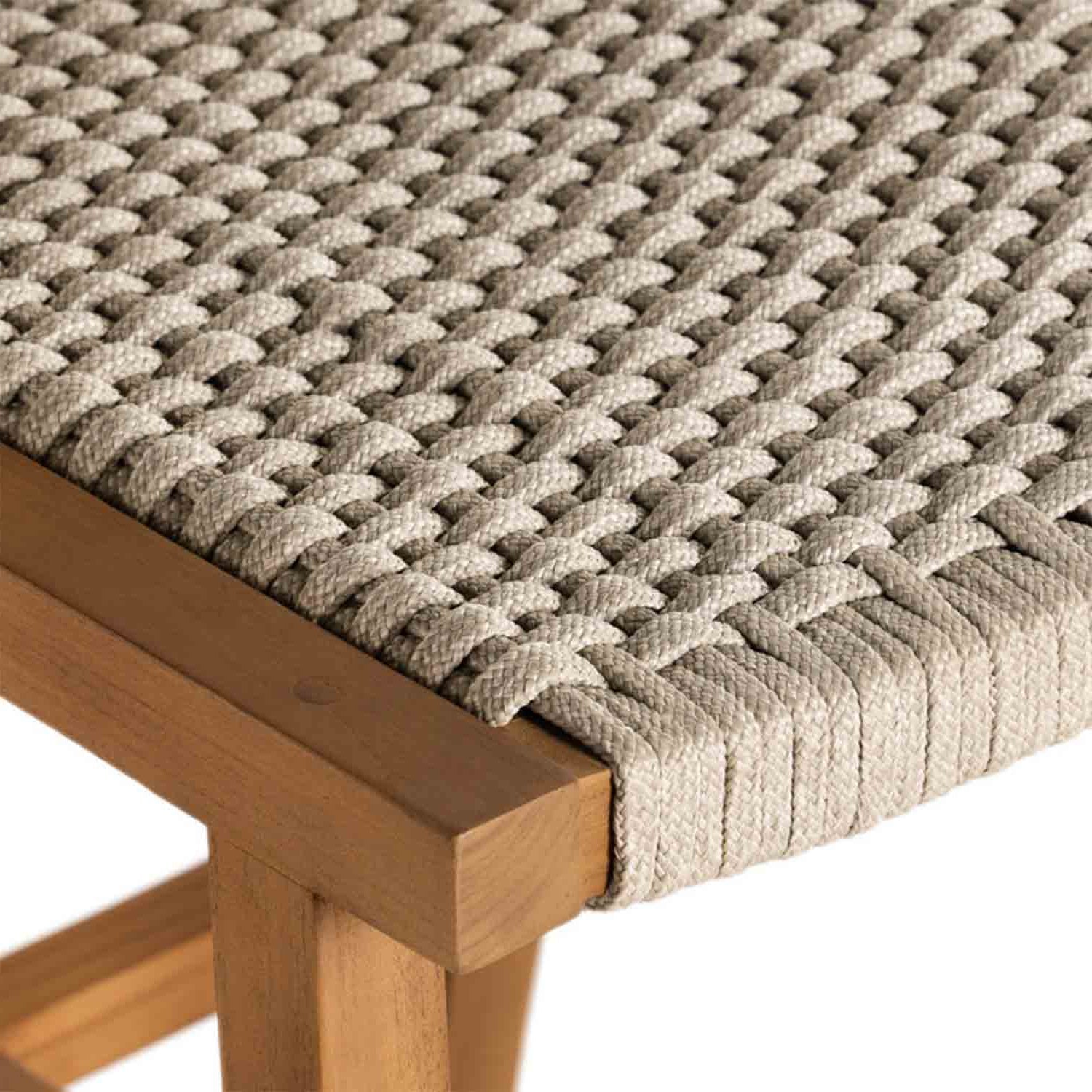 Close-up of a natural teak bar stool corner showing tightly woven beige rope seat straps wrapped over a solid teak wood frame.