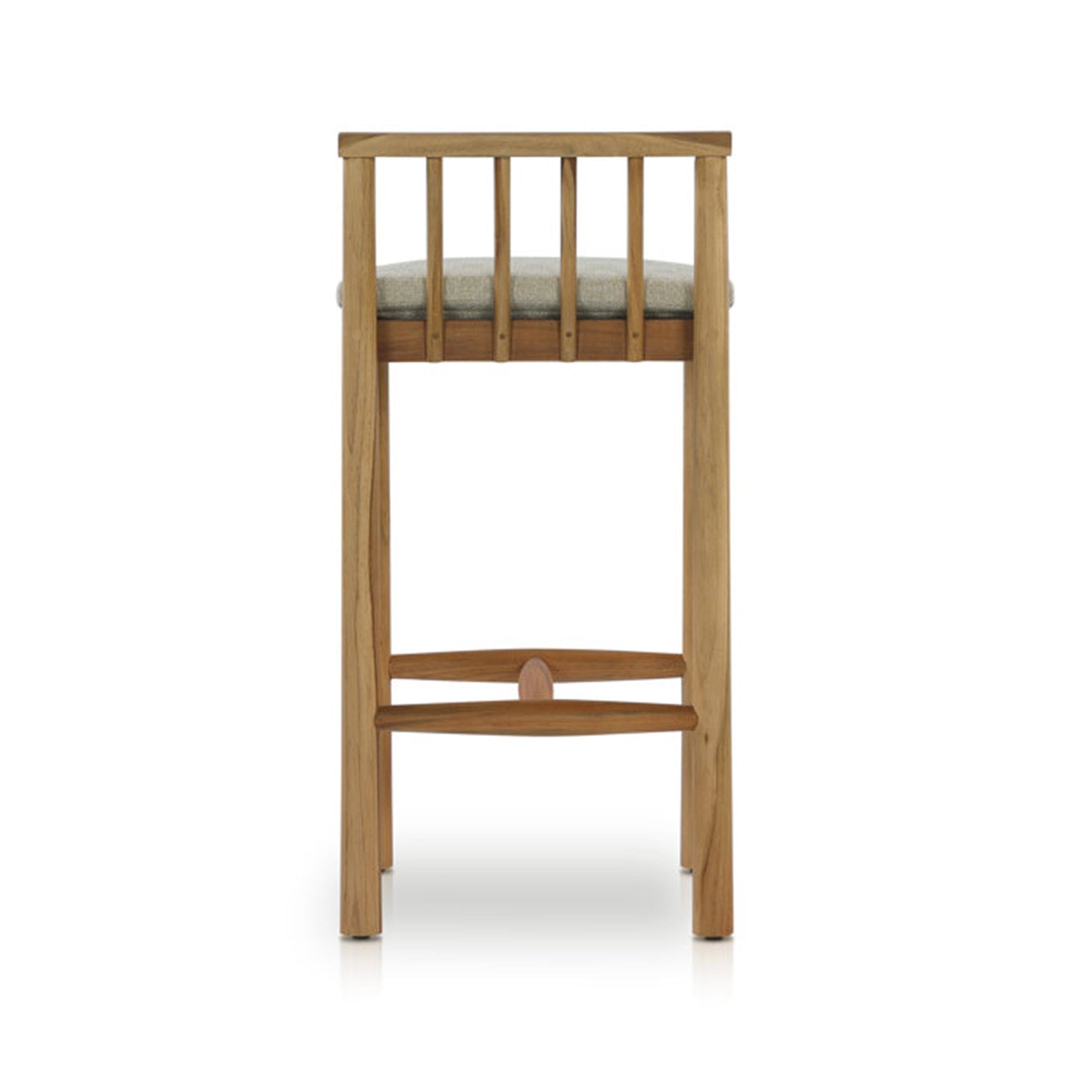 Rear view of an armless outdoor bar stool in natural teak with a light-gray upholstered seat, vertical slatted back and curved teak footrest in a coastal contemporary style.