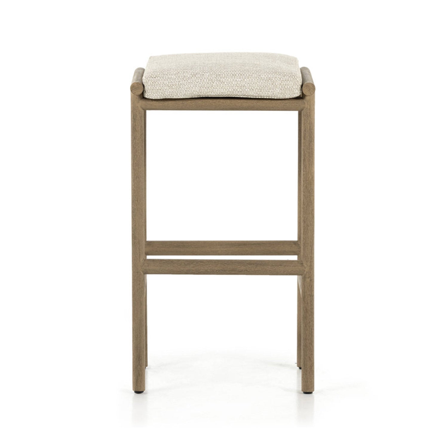 Front view of a backless teak bar stool with a light beige upholstered fabric seat cushion, slim squared wooden frame and horizontal footrest bars in a minimalist coastal-modern design for outdoor or patio use.