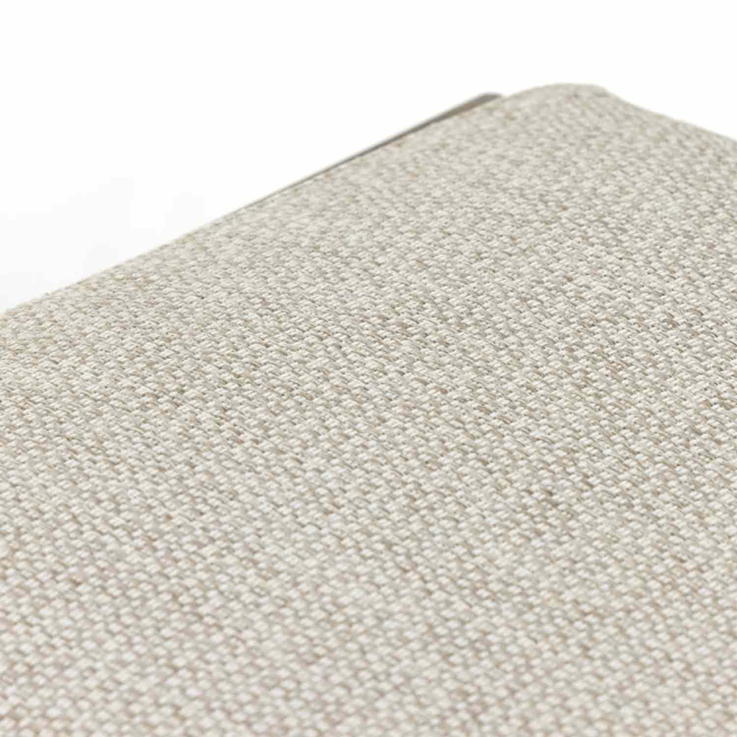 Close-up of beige woven outdoor upholstery on a backless teak bar stool seat, showing textured fabric weave and a sliver of teak frame at the edge.
