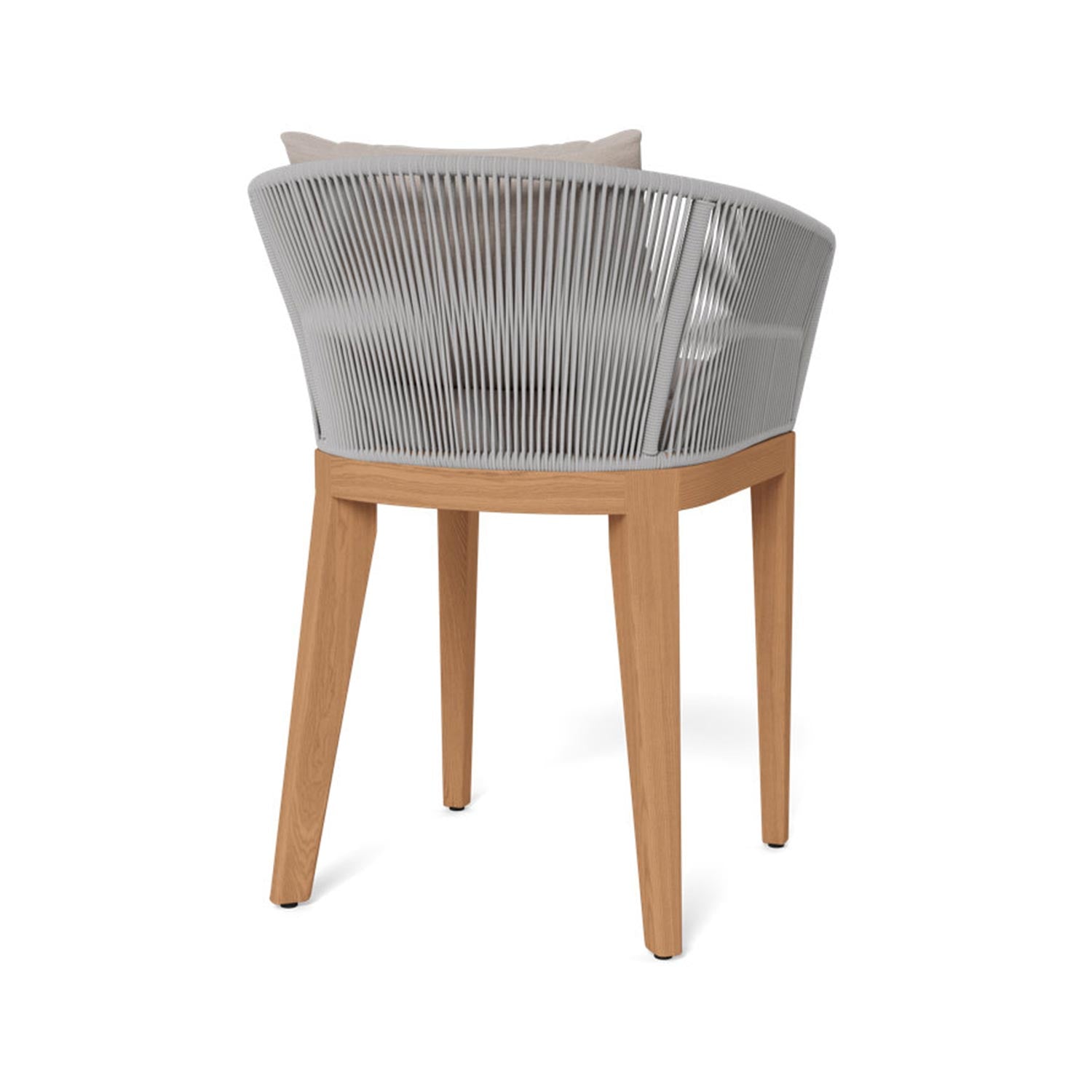 Rear three-quarter view of an outdoor bar stool featuring teak legs and frame, a light-gray woven rope back, and a beige upholstered seat cushion with a matching pillow.