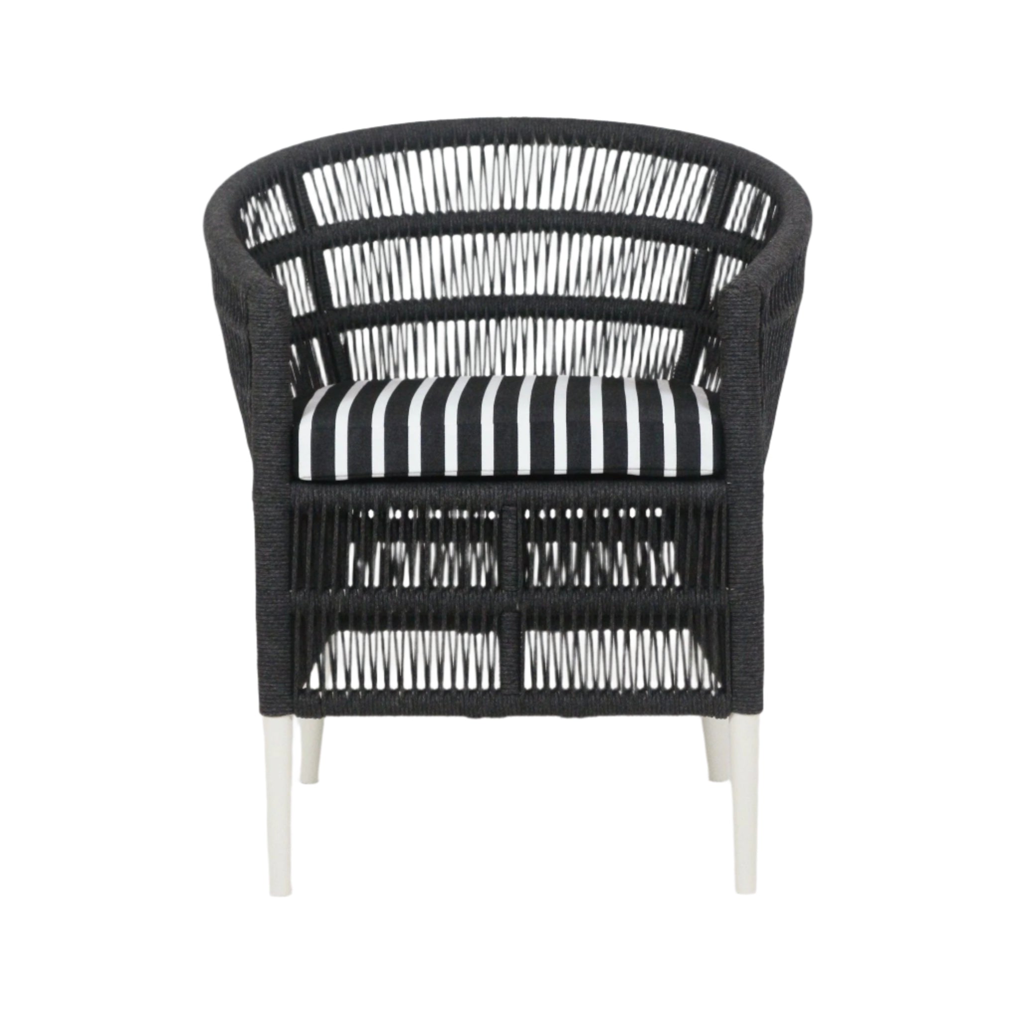 Front view of a coastal outdoor armchair with a black woven rope frame, white metal legs and a black-and-white striped Sunbrella fabric seat cushion.