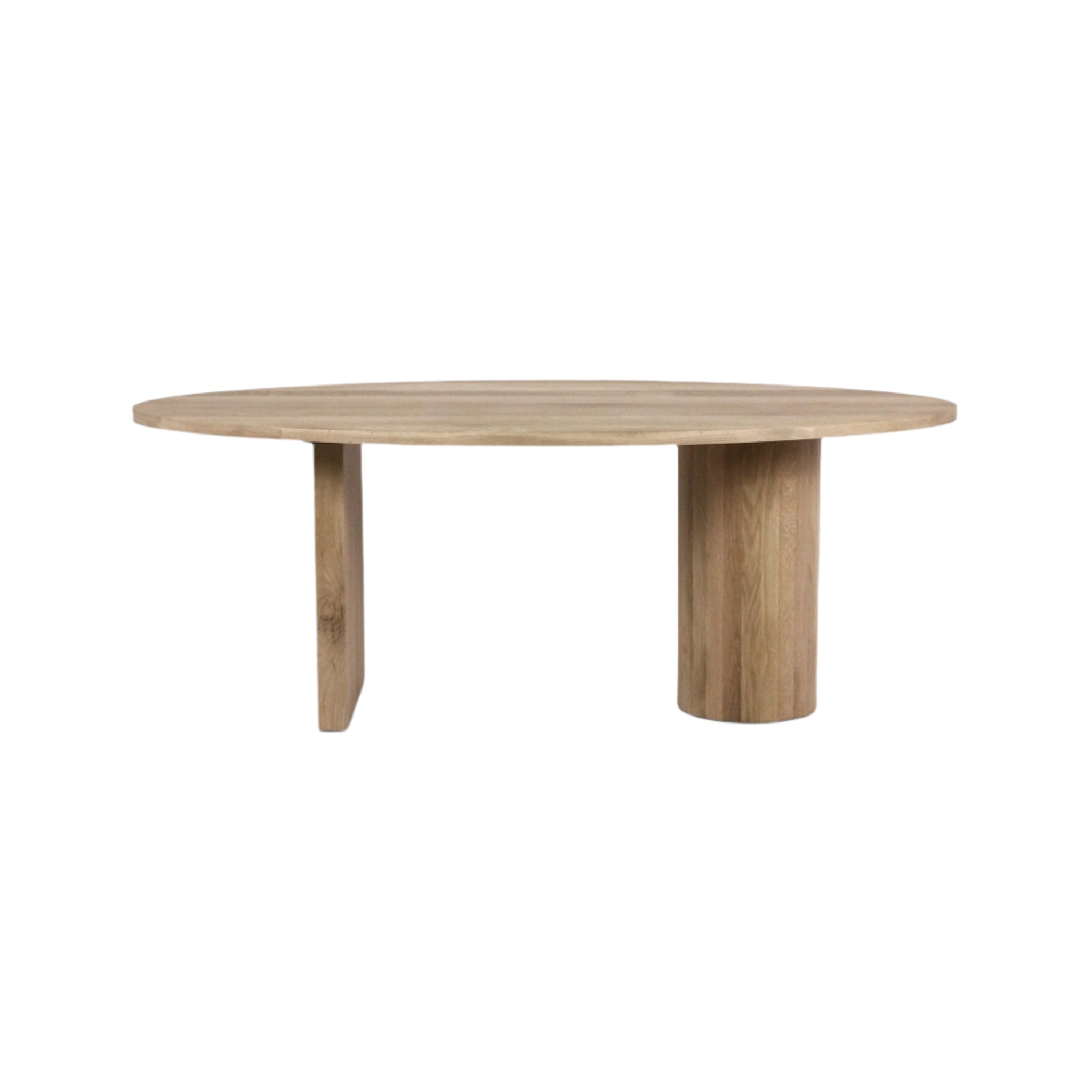 Round solid oak dining table in a natural teak-toned finish, with a slim circular top and an asymmetric base featuring one rectangular support and one cylindrical column.