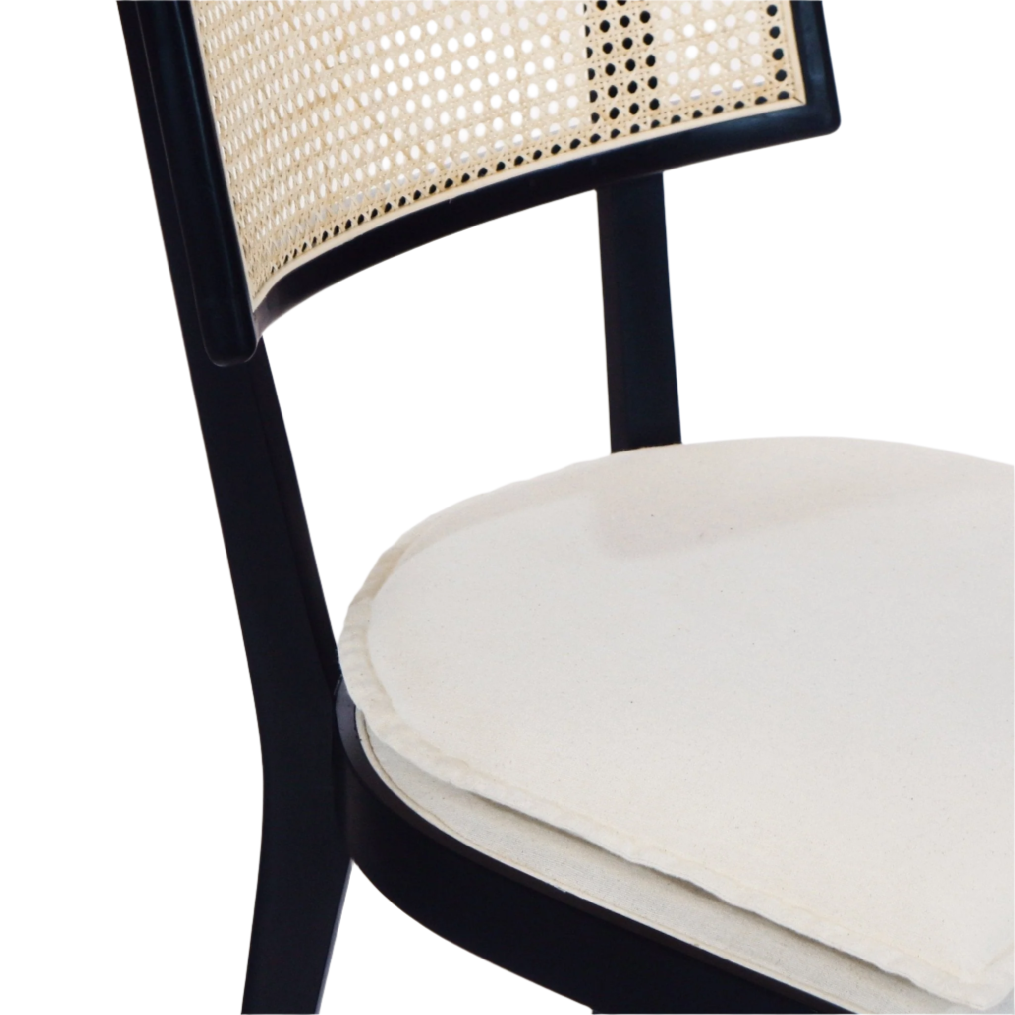 Close-up of a black wooden dining chair featuring a natural rattan cane backrest and a cream upholstered round seat cushion.