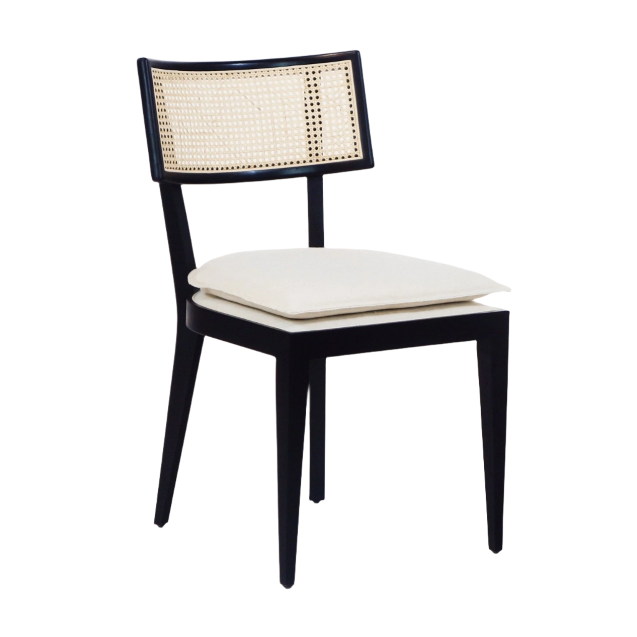 Armless black wooden dining chair with a natural rattan cane backrest and a cream upholstered seat cushion in a mid-century modern boho style.