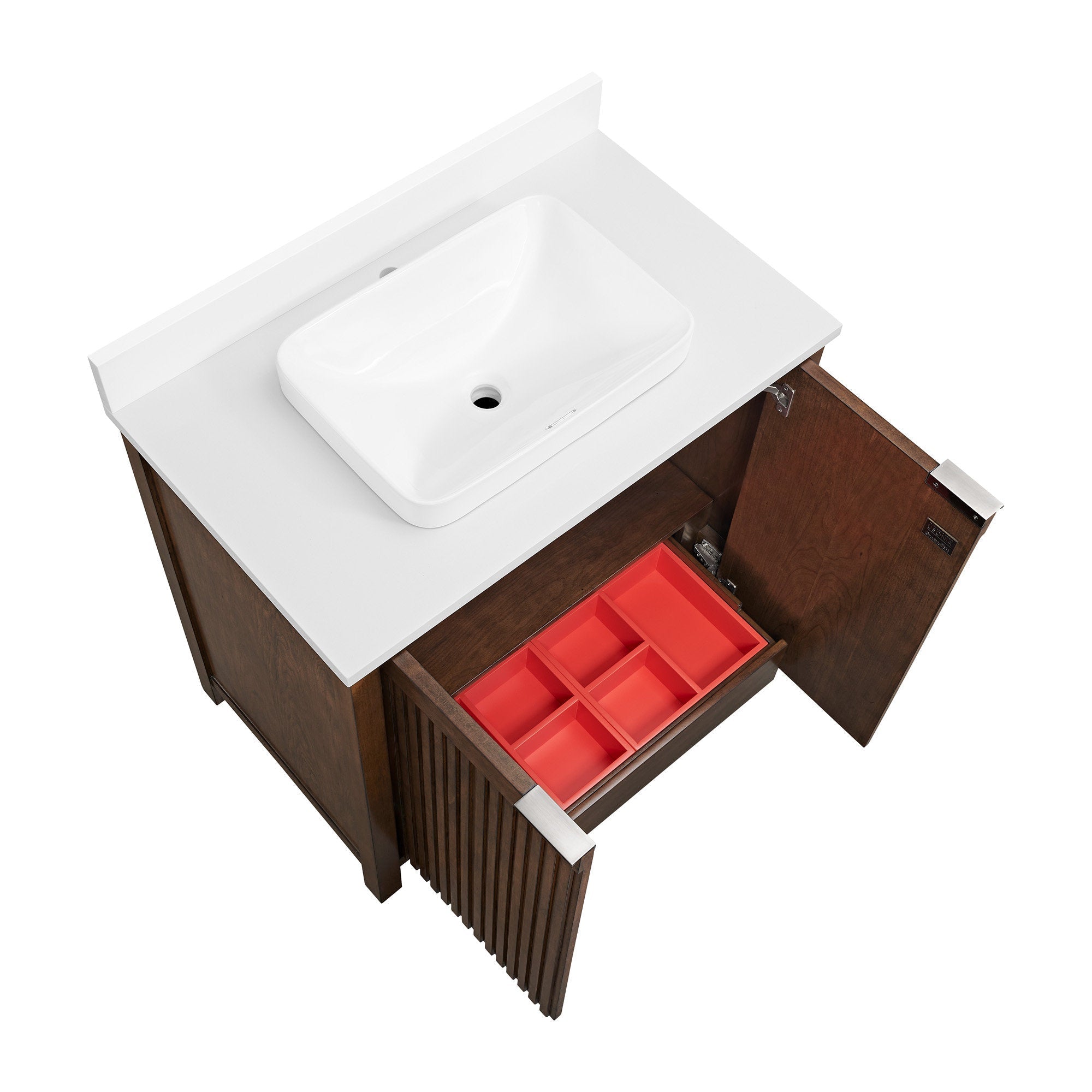 Top-down view of a modern solid wood bathroom vanity with fluted front, white stone countertop and rectangular white ceramic vessel sink; one door and a drawer with a red compartment organizer are open.