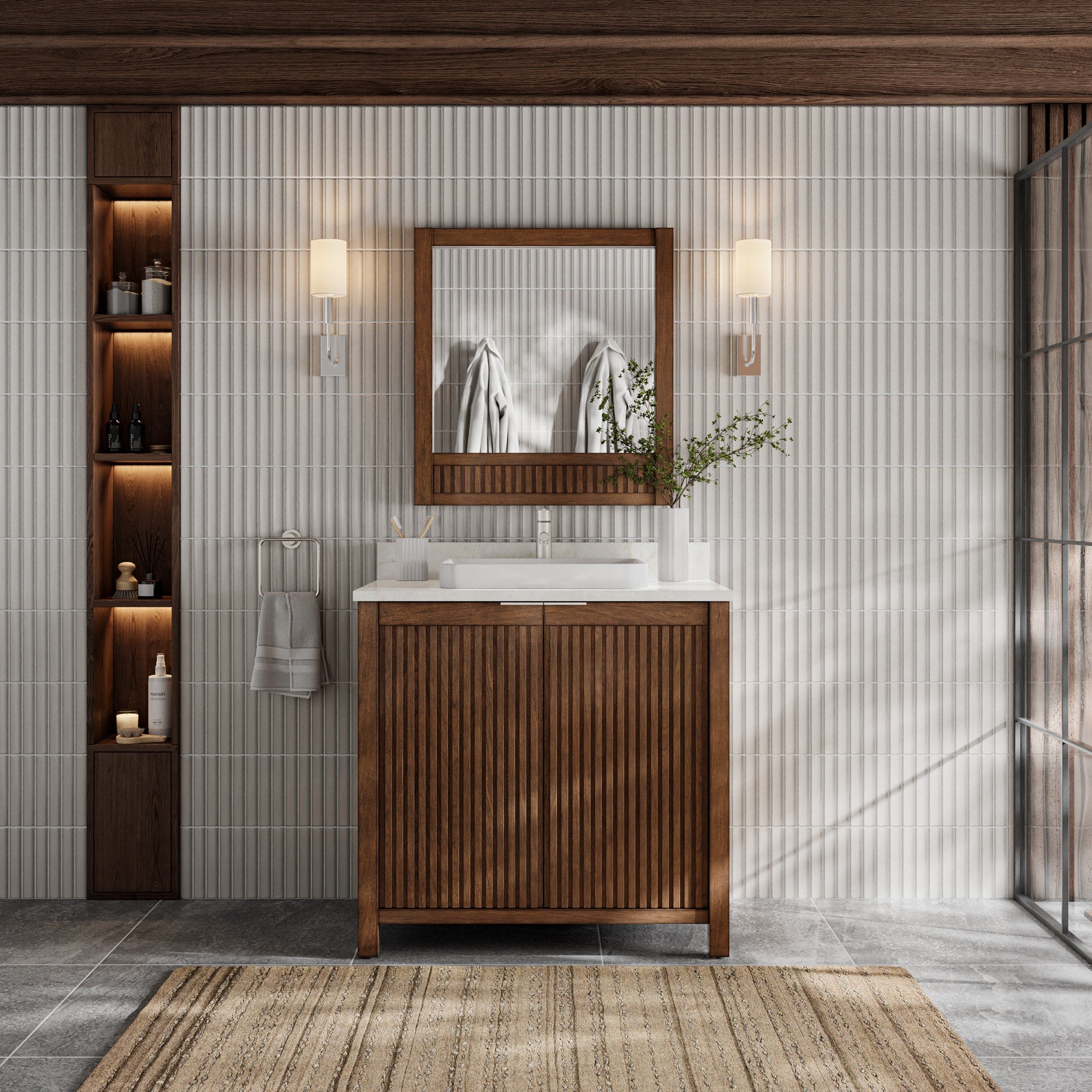 Modern single-sink bathroom vanity in natural solid wood with fluted cabinet doors and a stone countertop, shown with a wood-framed mirror, wall sconces and recessed shelving against white tile.