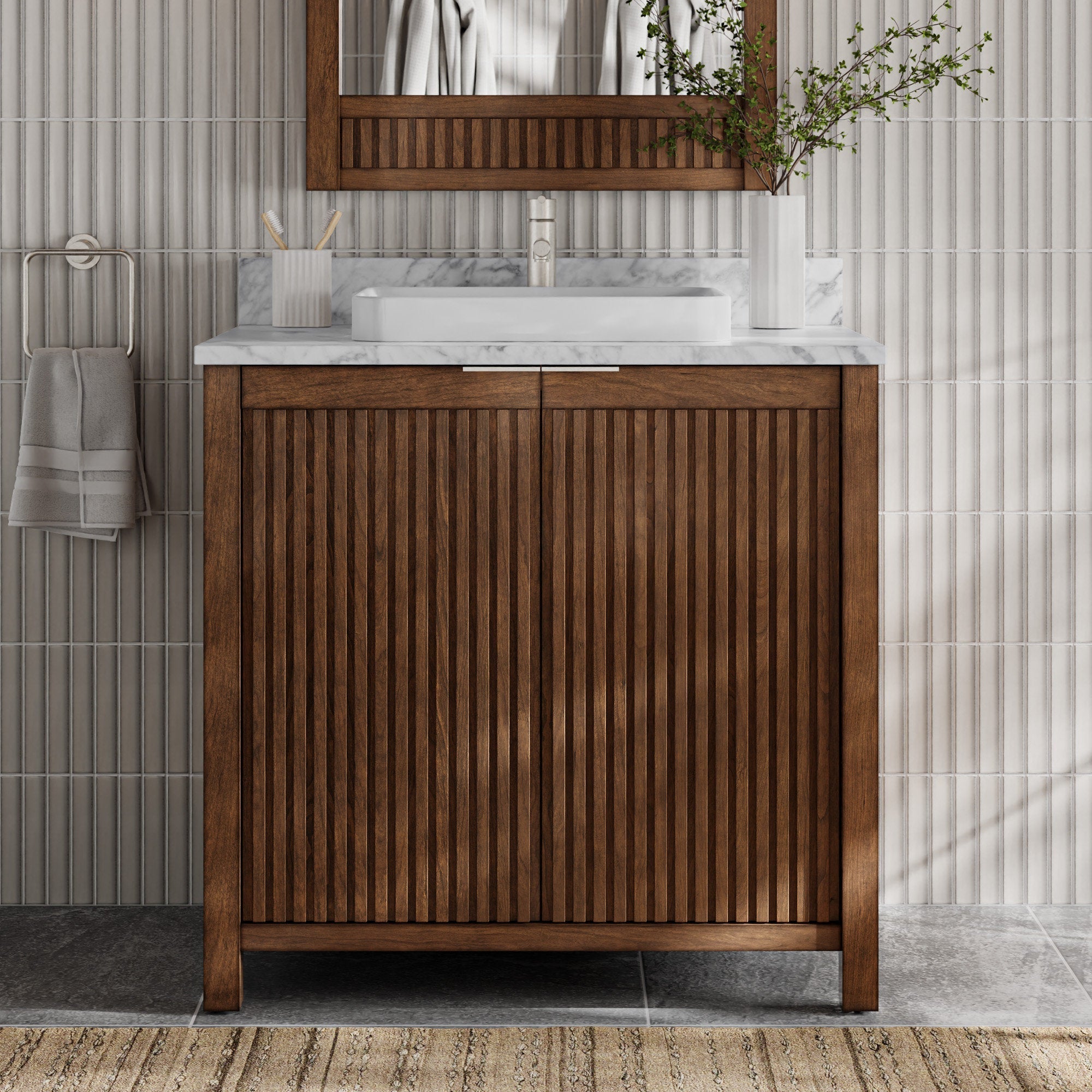 36-inch freestanding fluted solid-wood bathroom vanity in warm brown with a stone marble top, rectangular white vessel sink and single faucet, shown with a matching wood mirror, towel on ring and vase against ribbed tile.