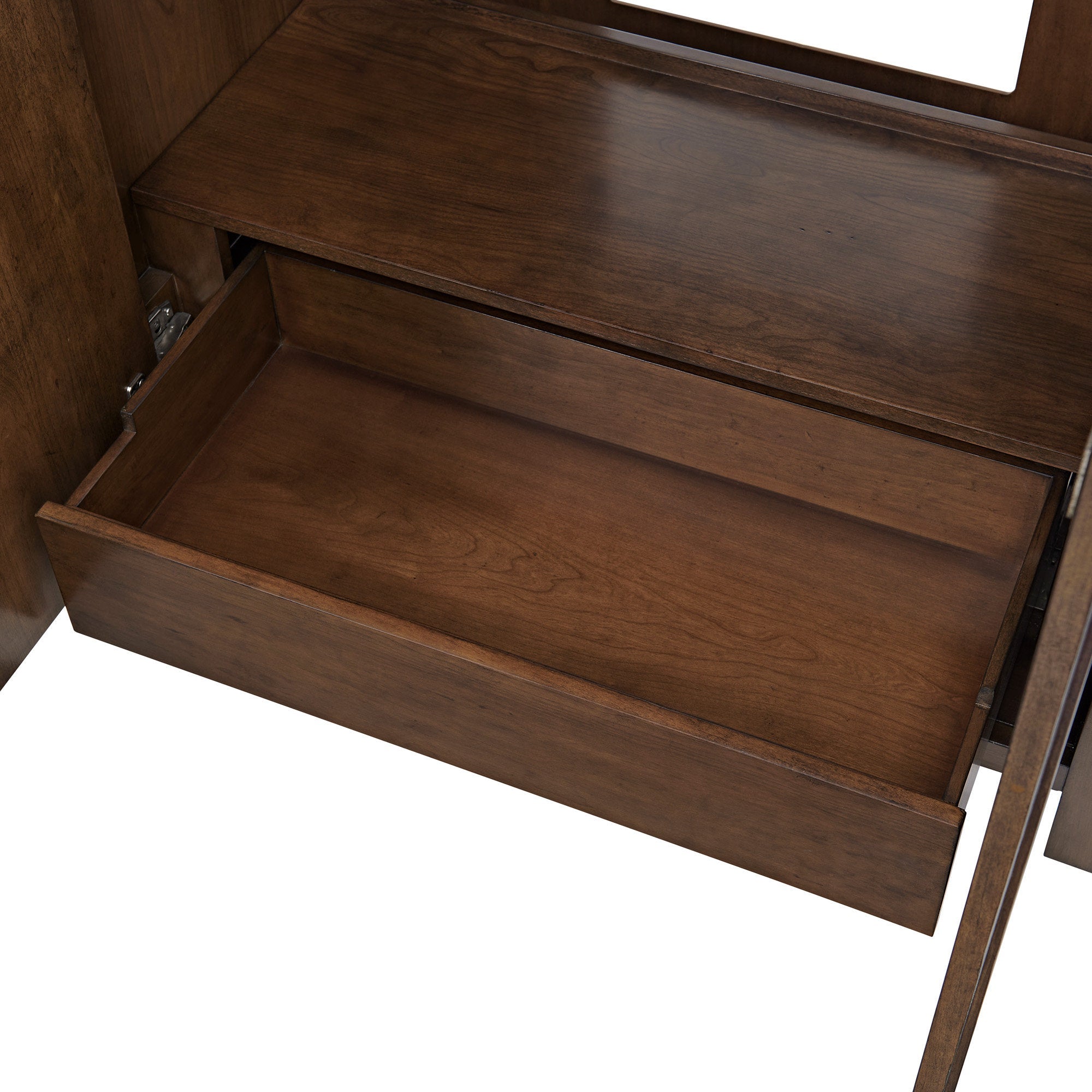 Open solid wood drawer with warm brown natural-wood grain and visible slide hardware inside a modern stone-colored single-sink bathroom vanity.