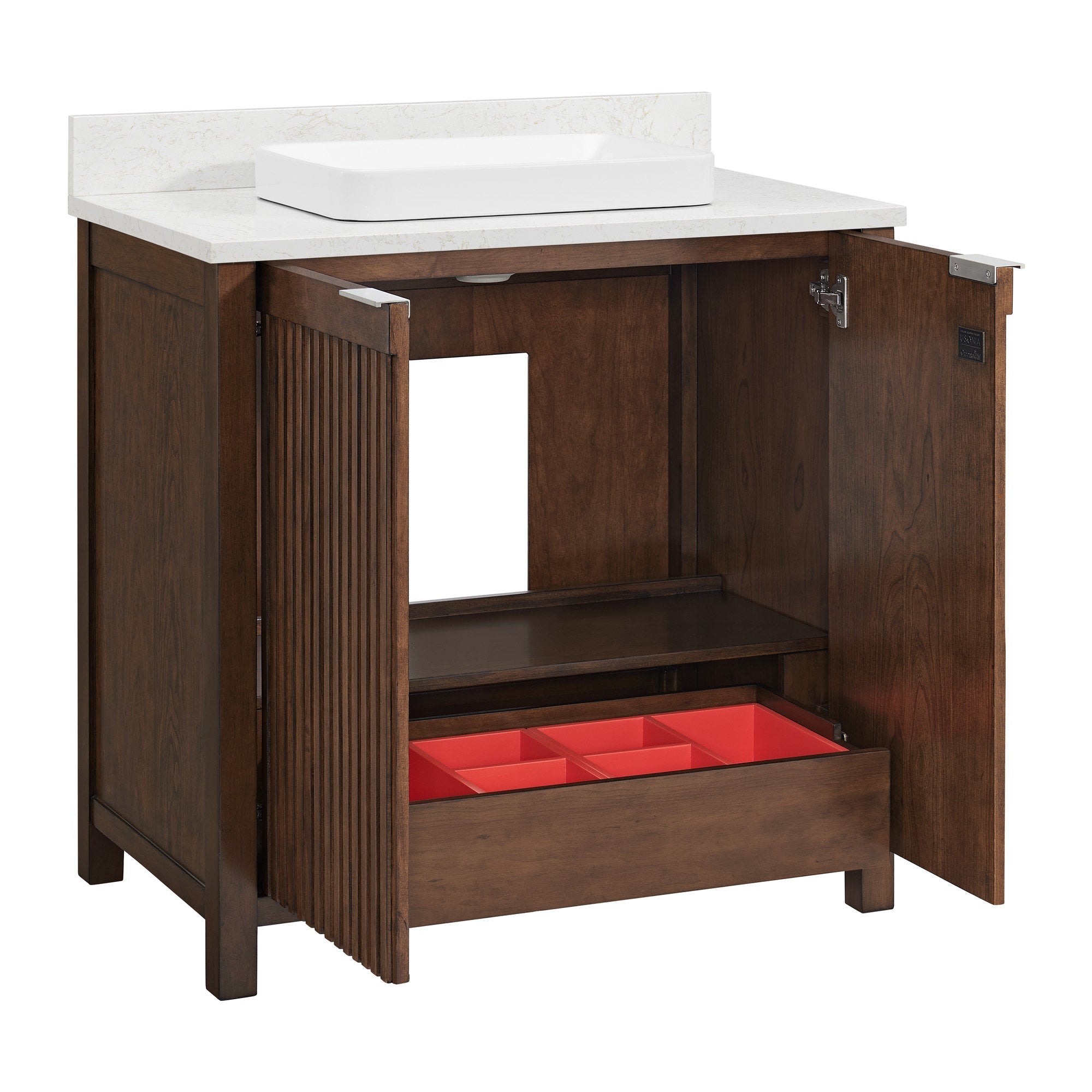 Freestanding solid wood single-sink bathroom vanity in warm brown with a stone-colored countertop and white rectangular ceramic vessel sink, fluted door detail, interior shelf and pull-out drawer with red divided organizer.