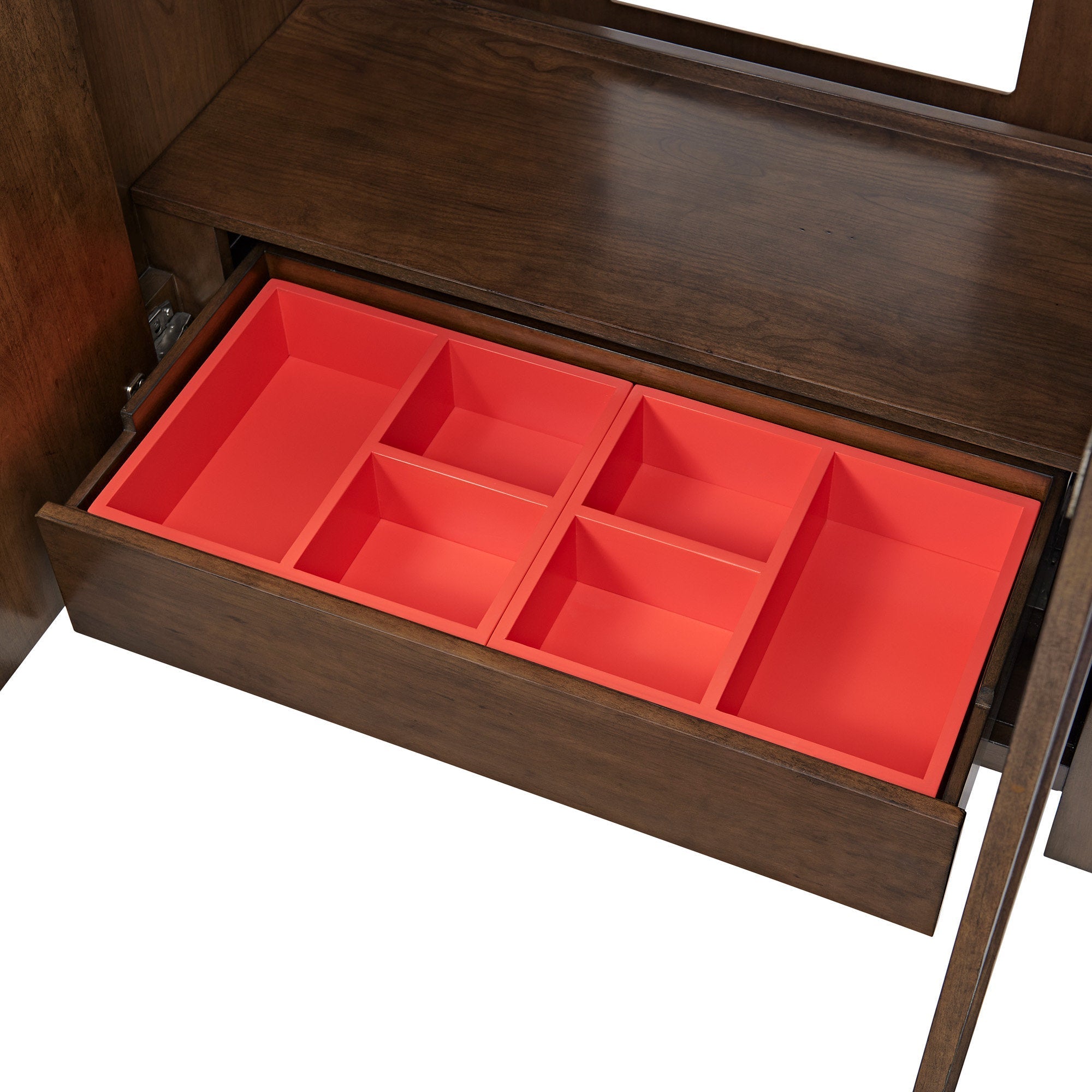 Open solid wood bathroom vanity drawer featuring a bright red removable organizer with multiple rectangular compartments beneath a stone-colored top.
