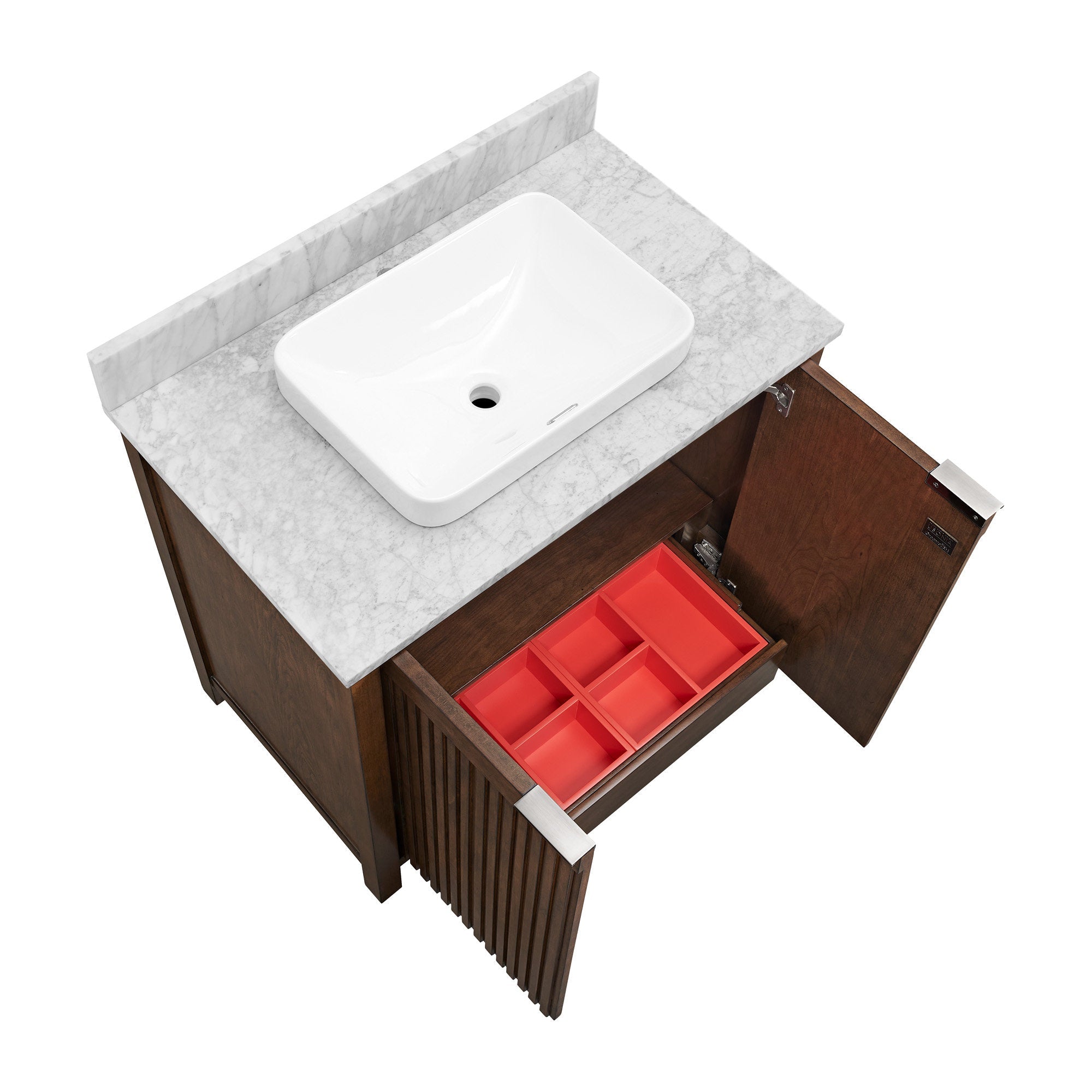 Top-down view of a single-sink modern solid wood bathroom vanity with a stone marble top and backsplash, white rectangular ceramic vessel sink, fluted brown cabinet doors, and an open drawer showing red organizer inserts and metal hardware.