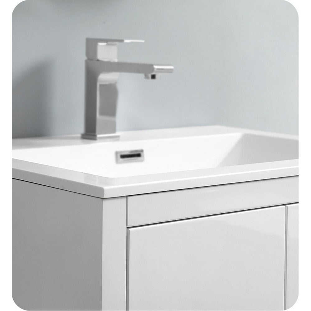 Close-up of a modern freestanding bathroom vanity showing a white ceramic integrated sink set into a stone-colored acrylic top, glossy white wooden cabinet front and a square chrome single-handle faucet.