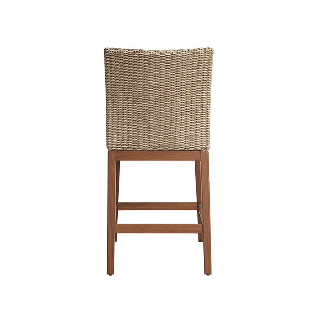 Rear view of an armless outdoor bar stool with a woven natural-fiber back and teak wood legs with footrest, shown on a white background.