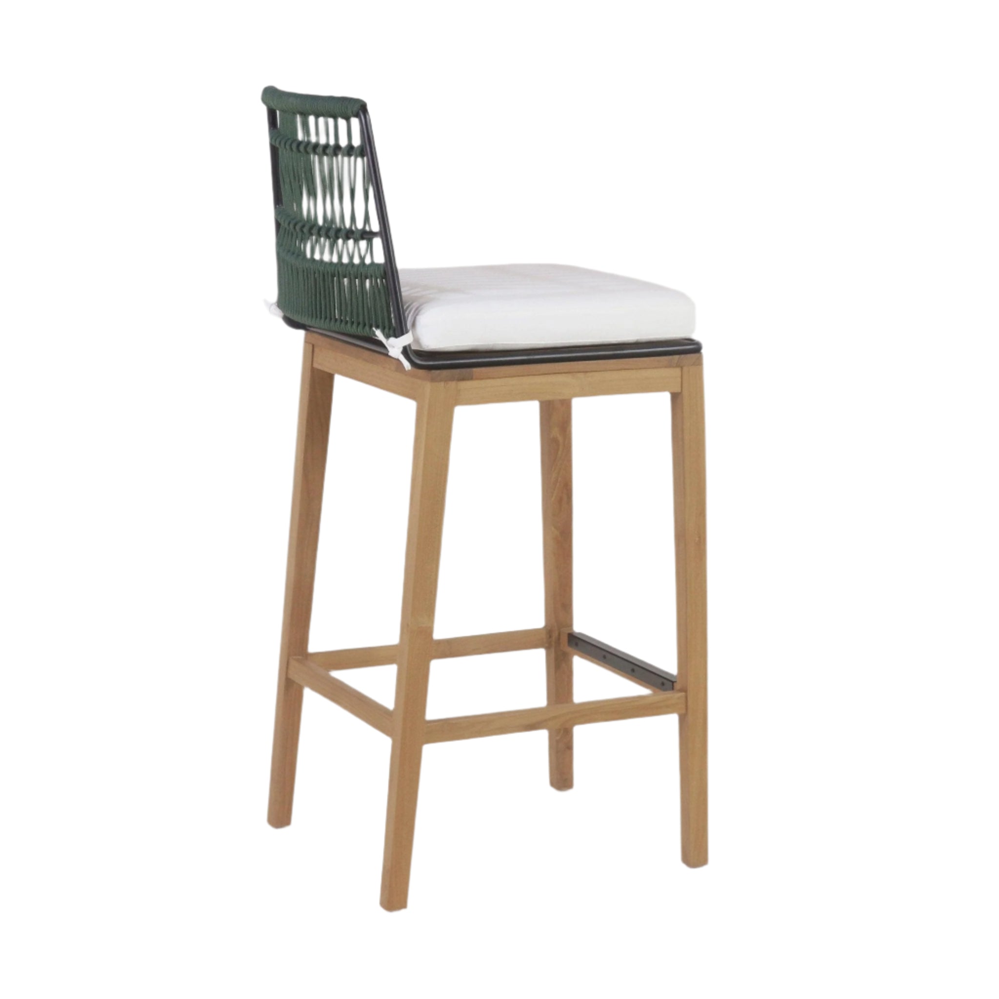 Side view of an outdoor mid-century modern bar stool with a teak wood frame, green woven rope back, black metal seat trim and footrest, and a white cushioned seat.