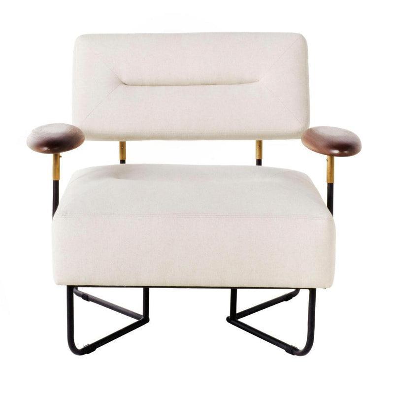 Off-white fabric upholstered low lounge chair with a rectangular padded back and wide cushioned seat, brown wooden arm pads on brass-accented metal supports, and a black metal sled-style base.