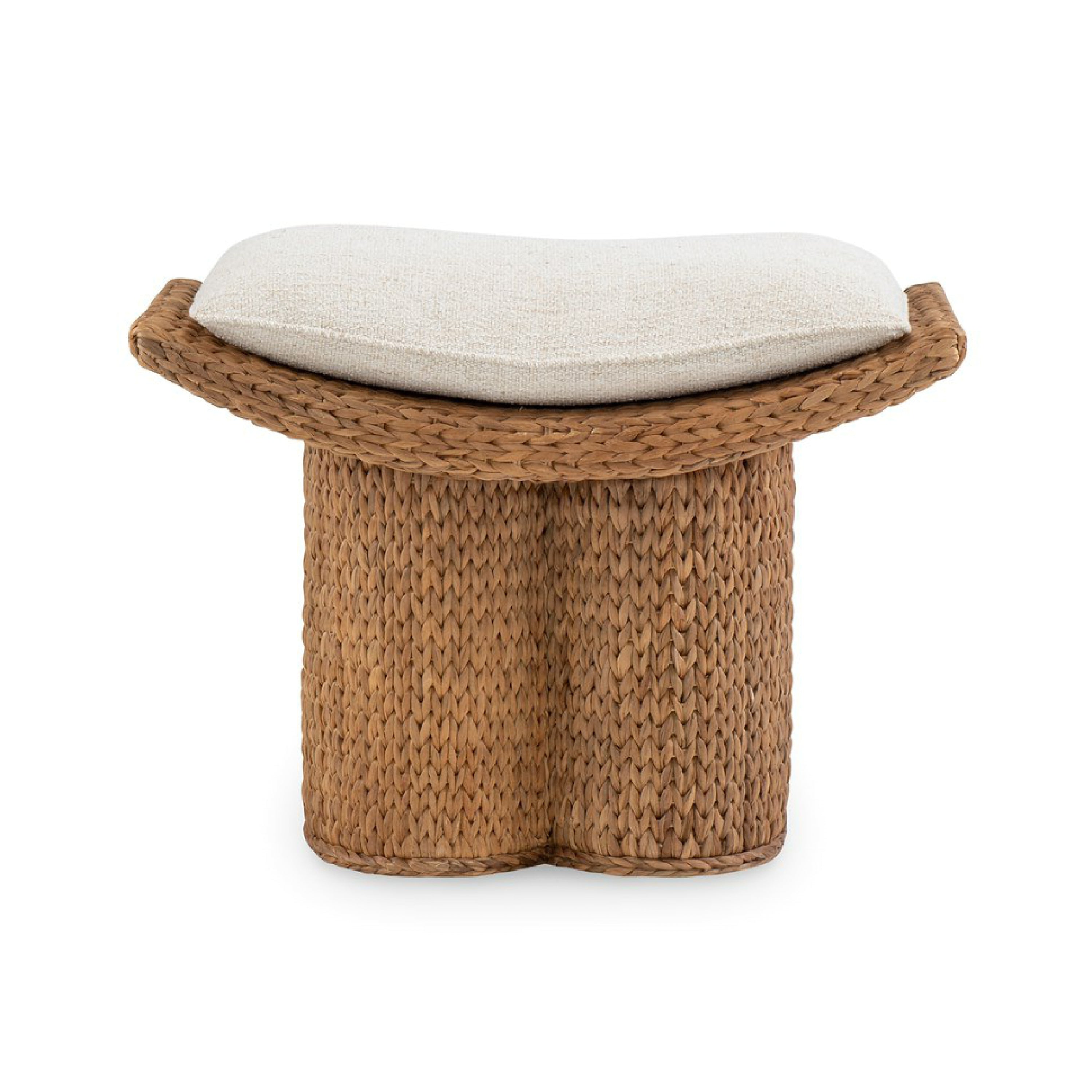 Handwoven natural water hyacinth stool with a double-column woven base and a removable off-white fabric cushion on a gently curved top.