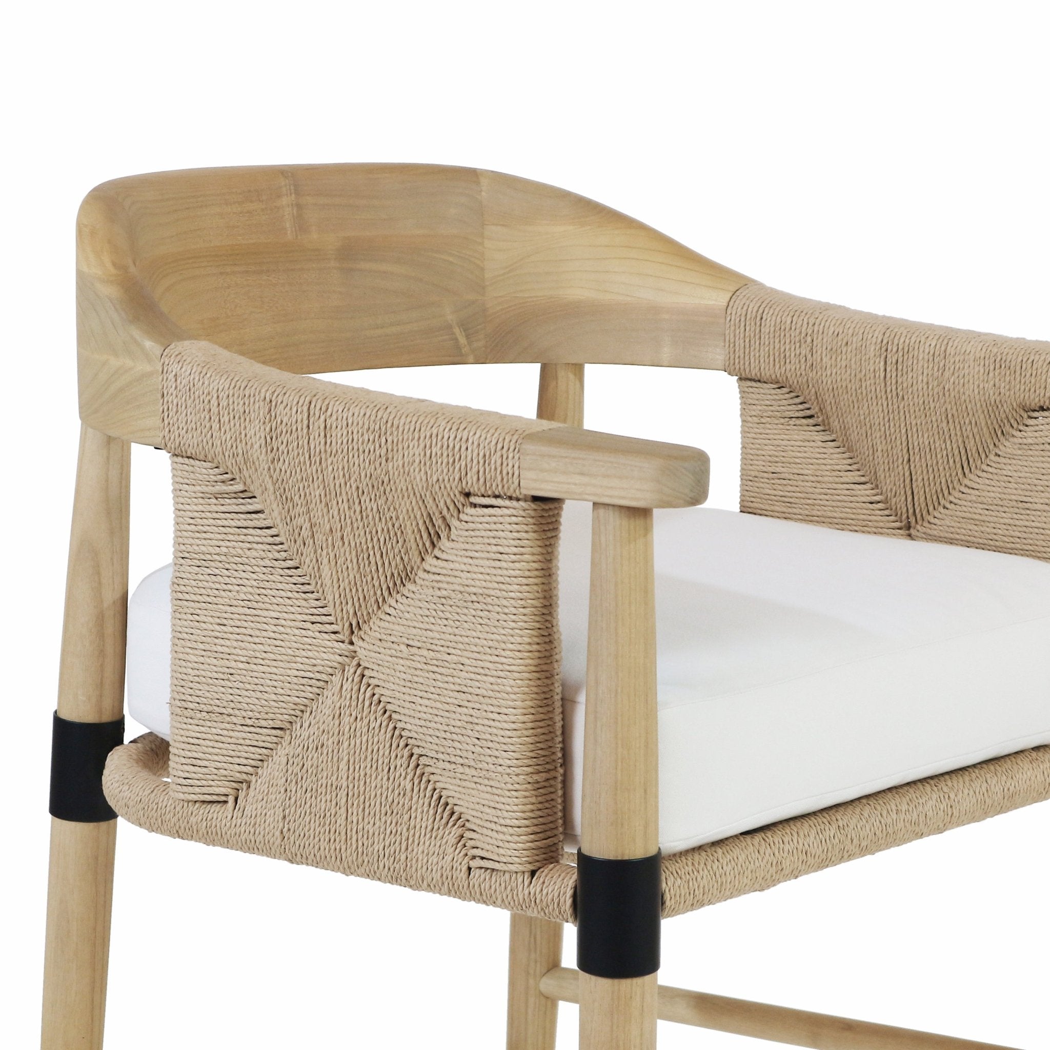Close-up of a natural wood bar stool showing a curved wood frame, woven natural rope back and arms with an X pattern, white upholstered seat cushion, and black metal leg collars.