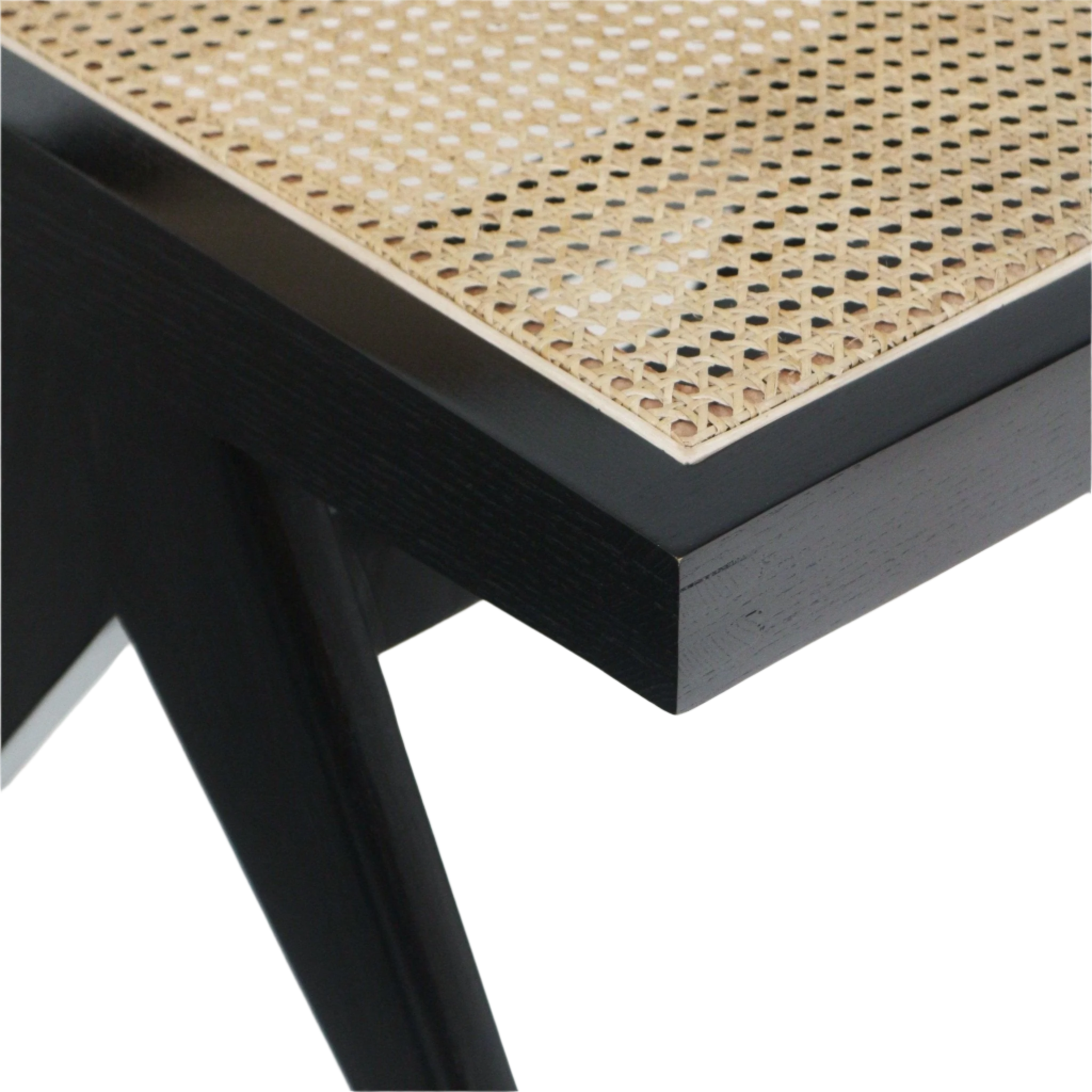 Close-up of an armless side chair corner showing natural cane Vienna weave seat inset into a black solid wood frame with a tapered black leg.